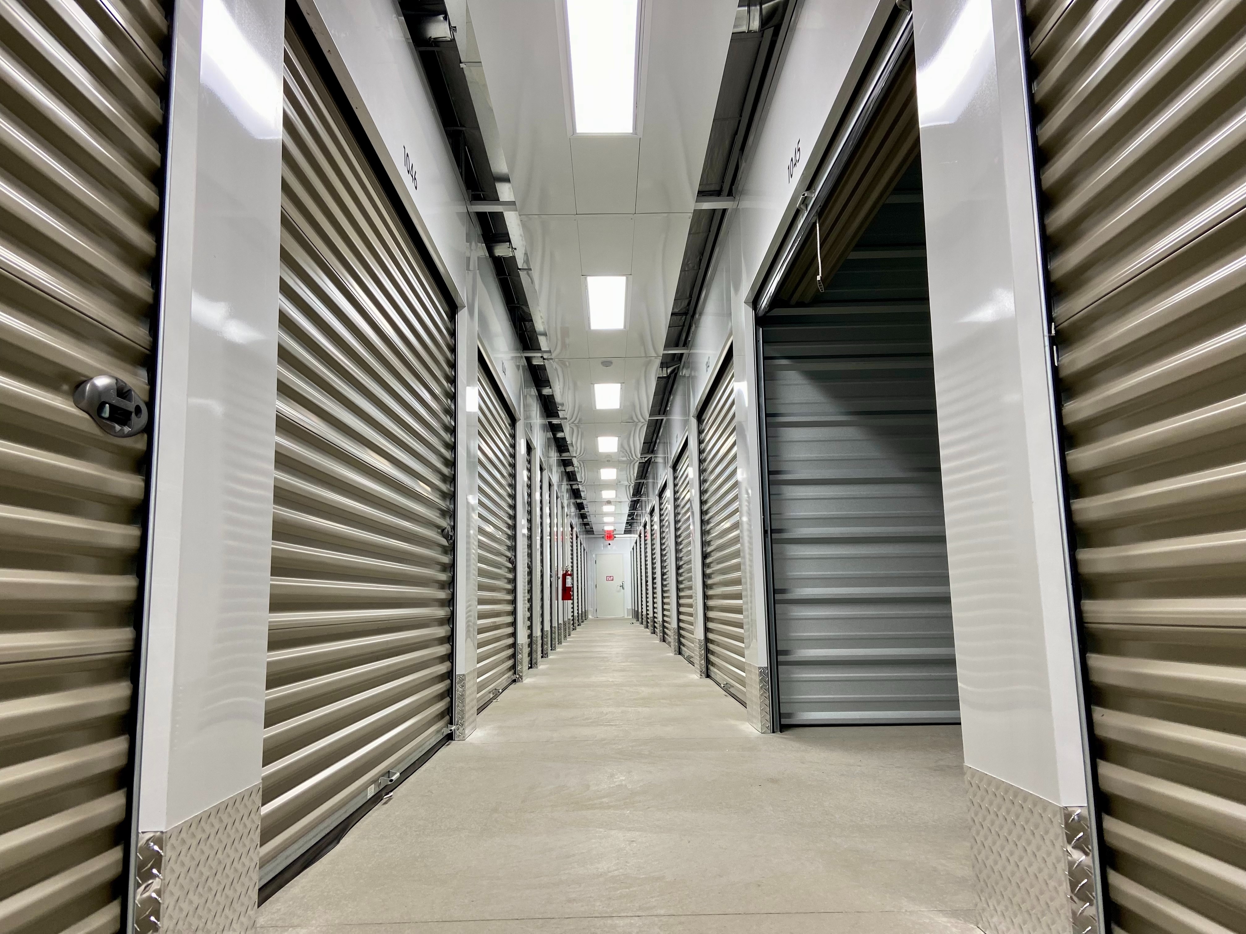Climate-controlled storage hallway with brightly lit interior units at Storage Junction in Genoa City, WI
