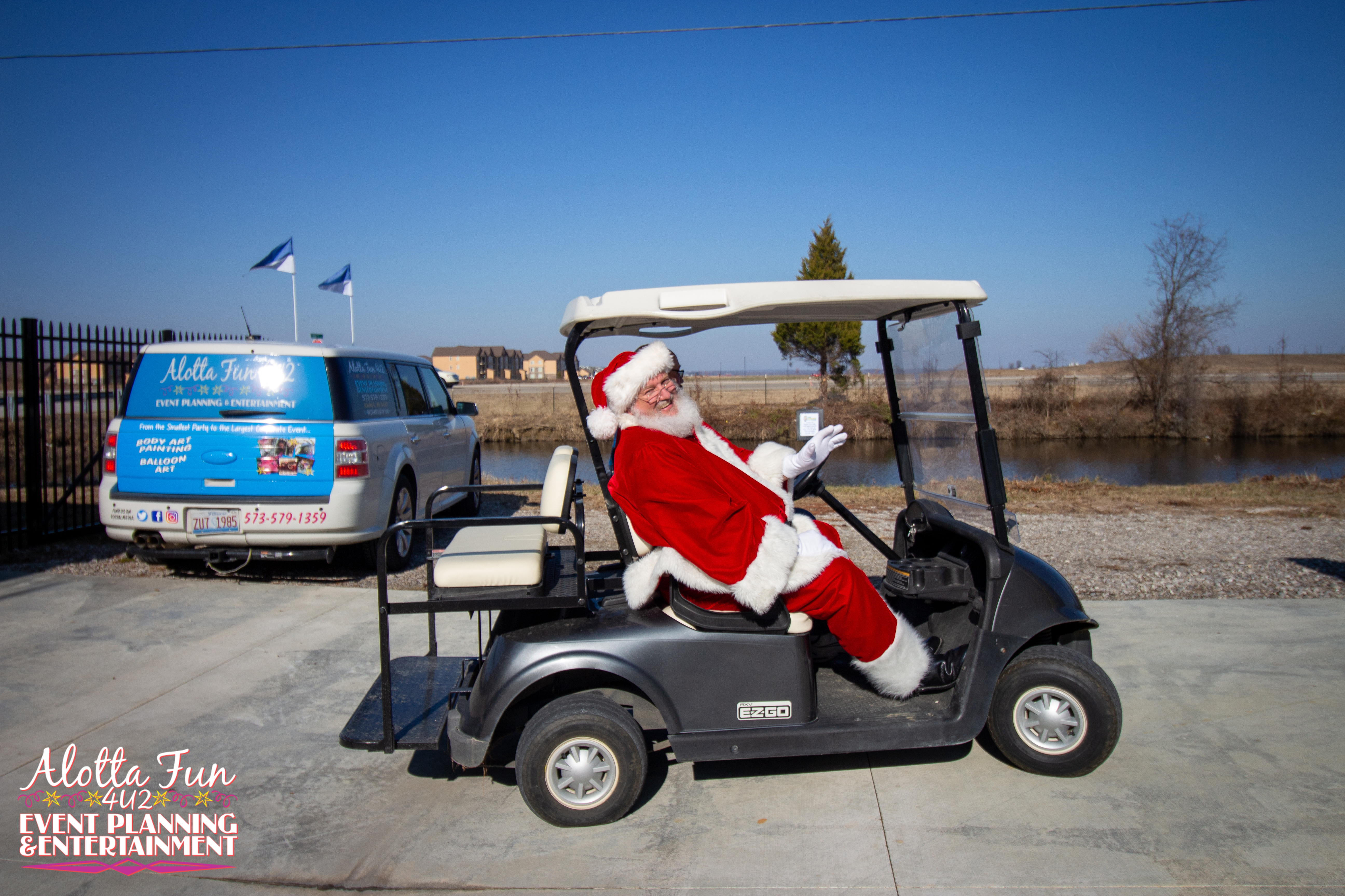 santa riding in a golf cart