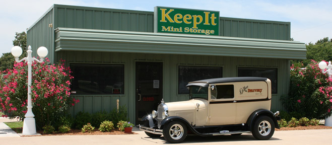 Outside of KeepIt Mini Storage in Mineola,TX with an antique car parked out front.