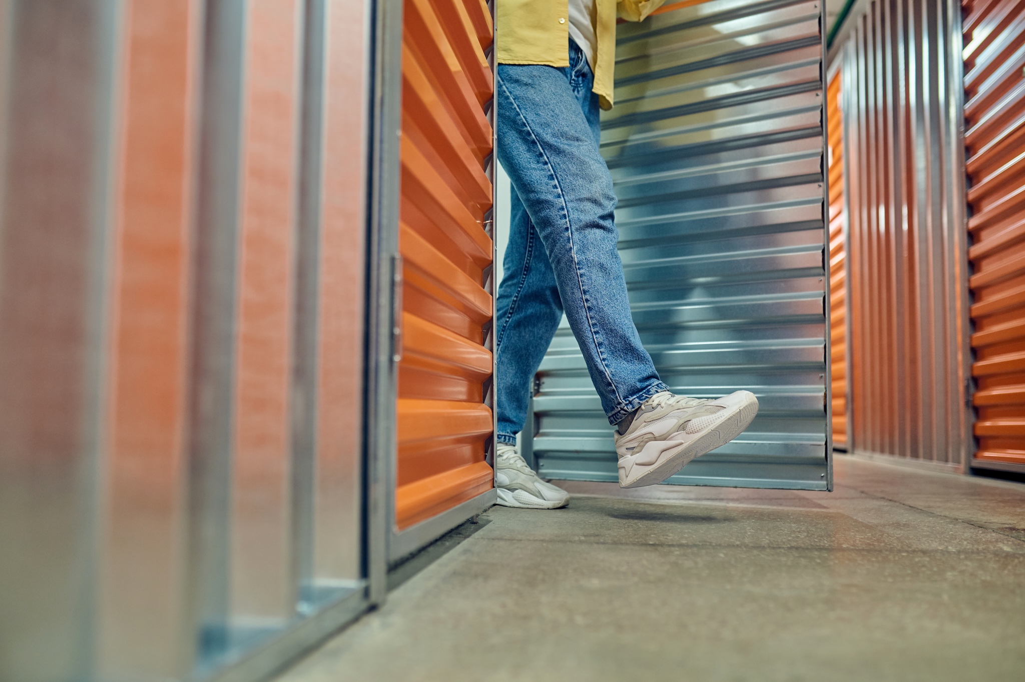 Man walking out of storage unit.