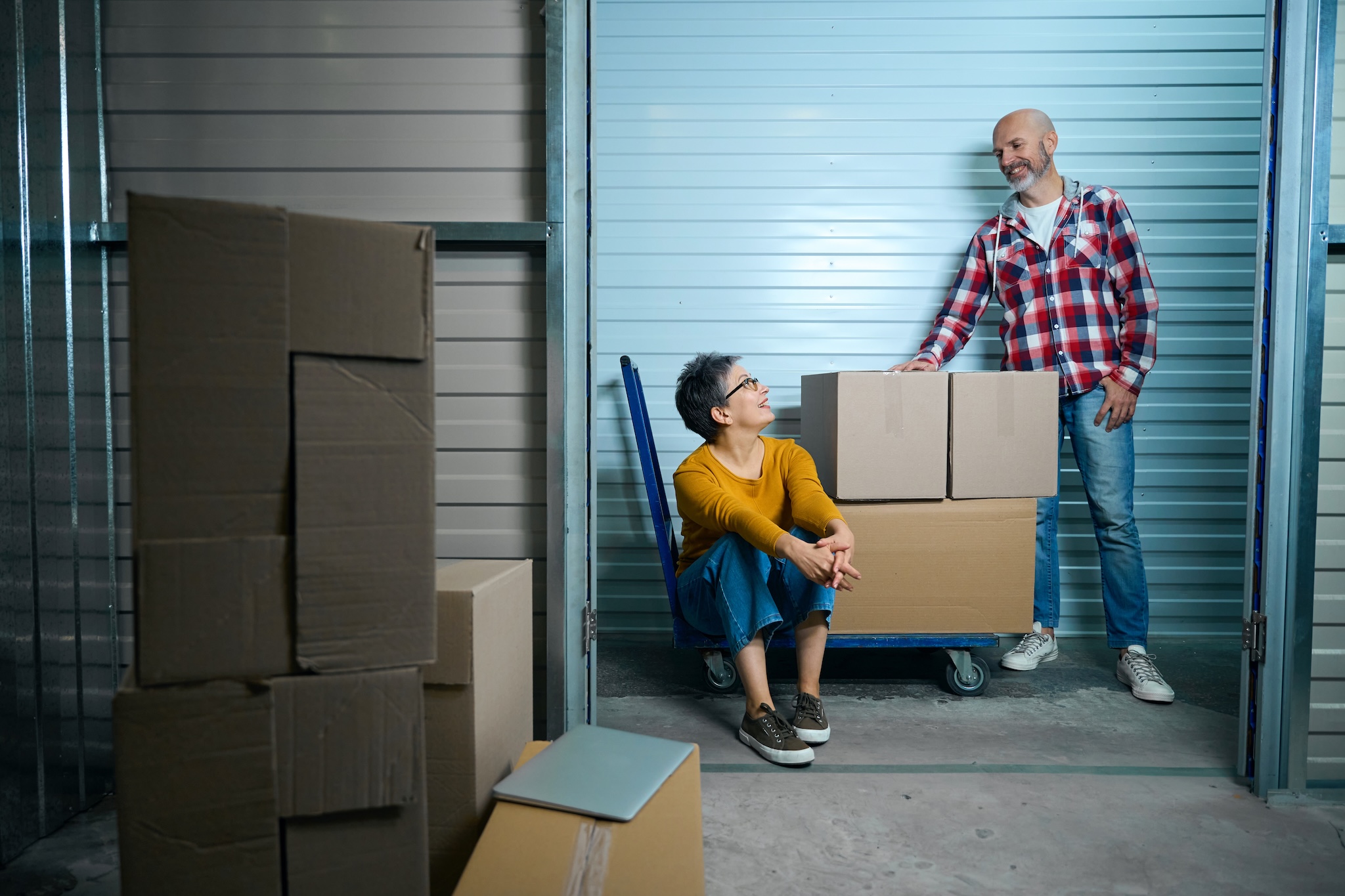 Couple with boxes on moving cart.