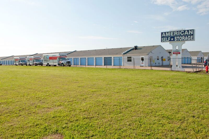 self storage facility with perimeter fencing and rental trucks