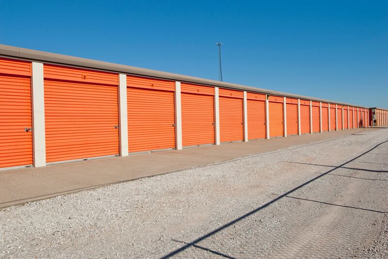 row of drive up self storage units with large door and a wide driving lane