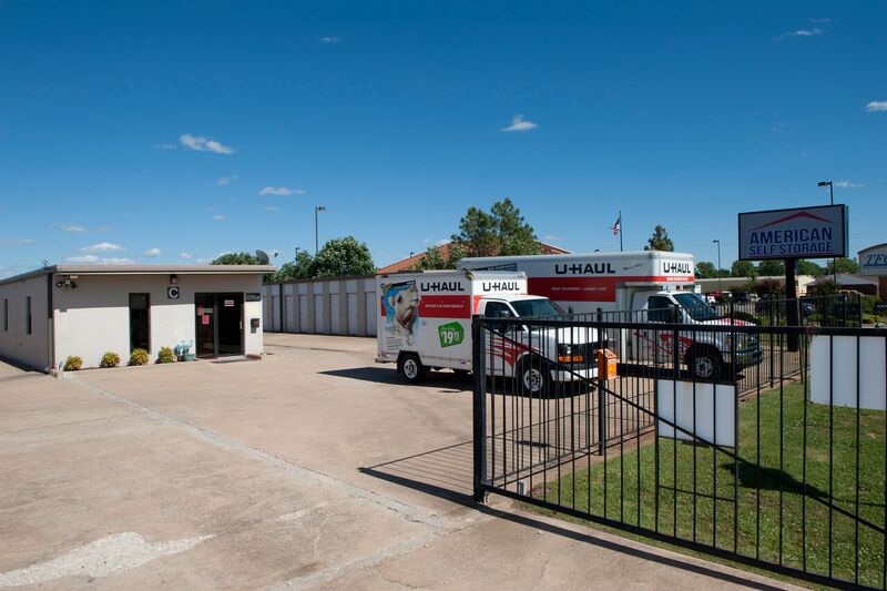 self storage facility with rental trucks behind automatic fence and gate