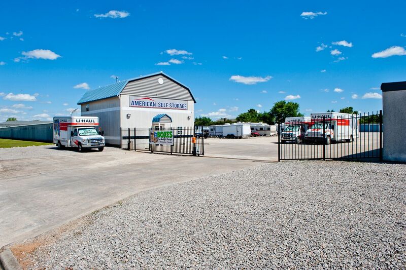 a fenced and gated self storage facility with rentable moving trucks