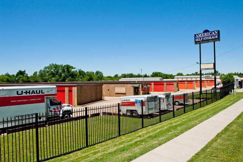 self storage buildings and uhaul trucks behind perimeter fencing