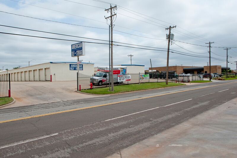 self storage facility with perimeter gate and parked moving truck