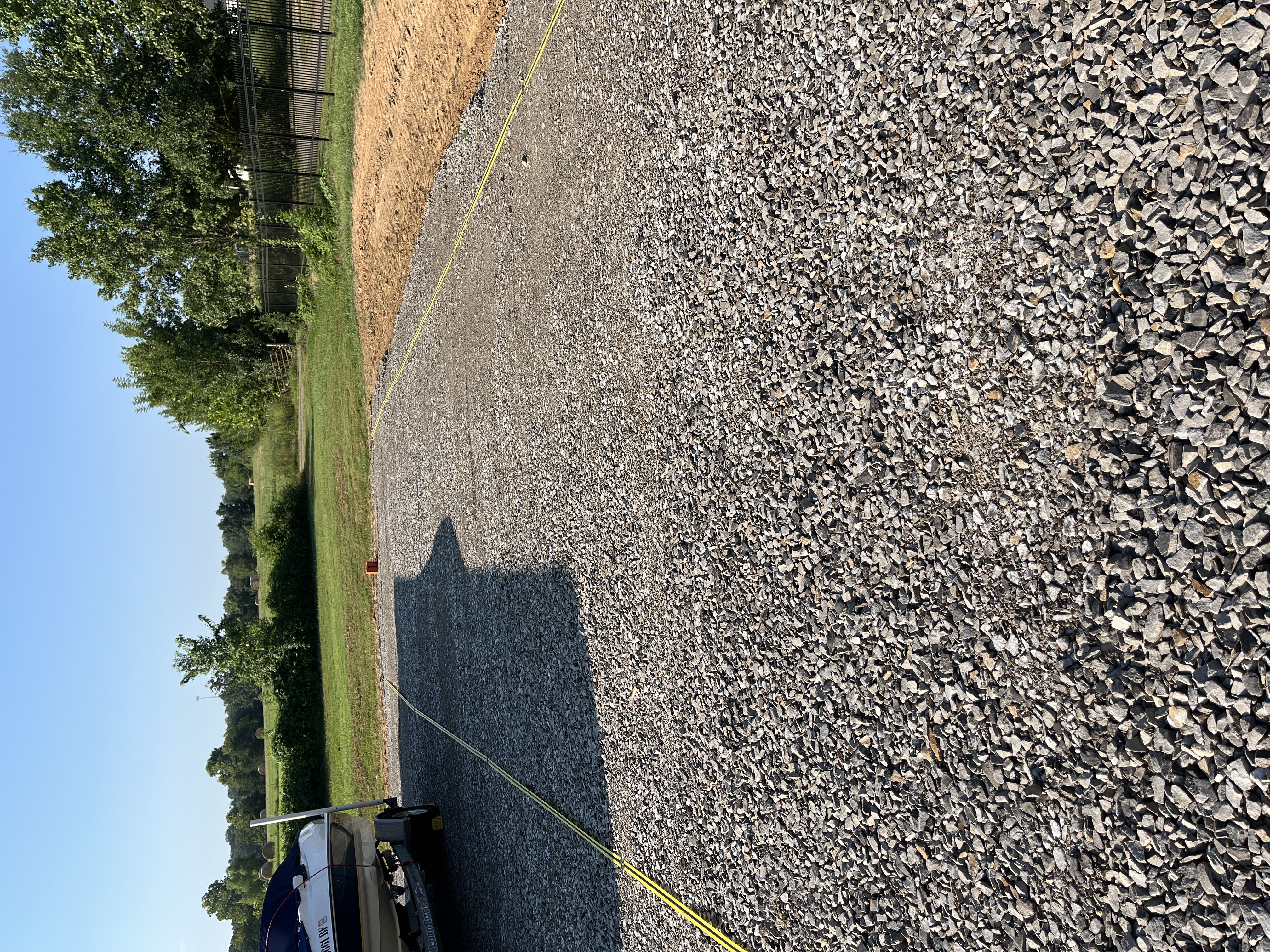 Secure outdoor parking spaces at Locked Up Storage in Greenwood, AR, featuring designated spots for boats, RVs, and trailers inside a fenced, well-lit facility.