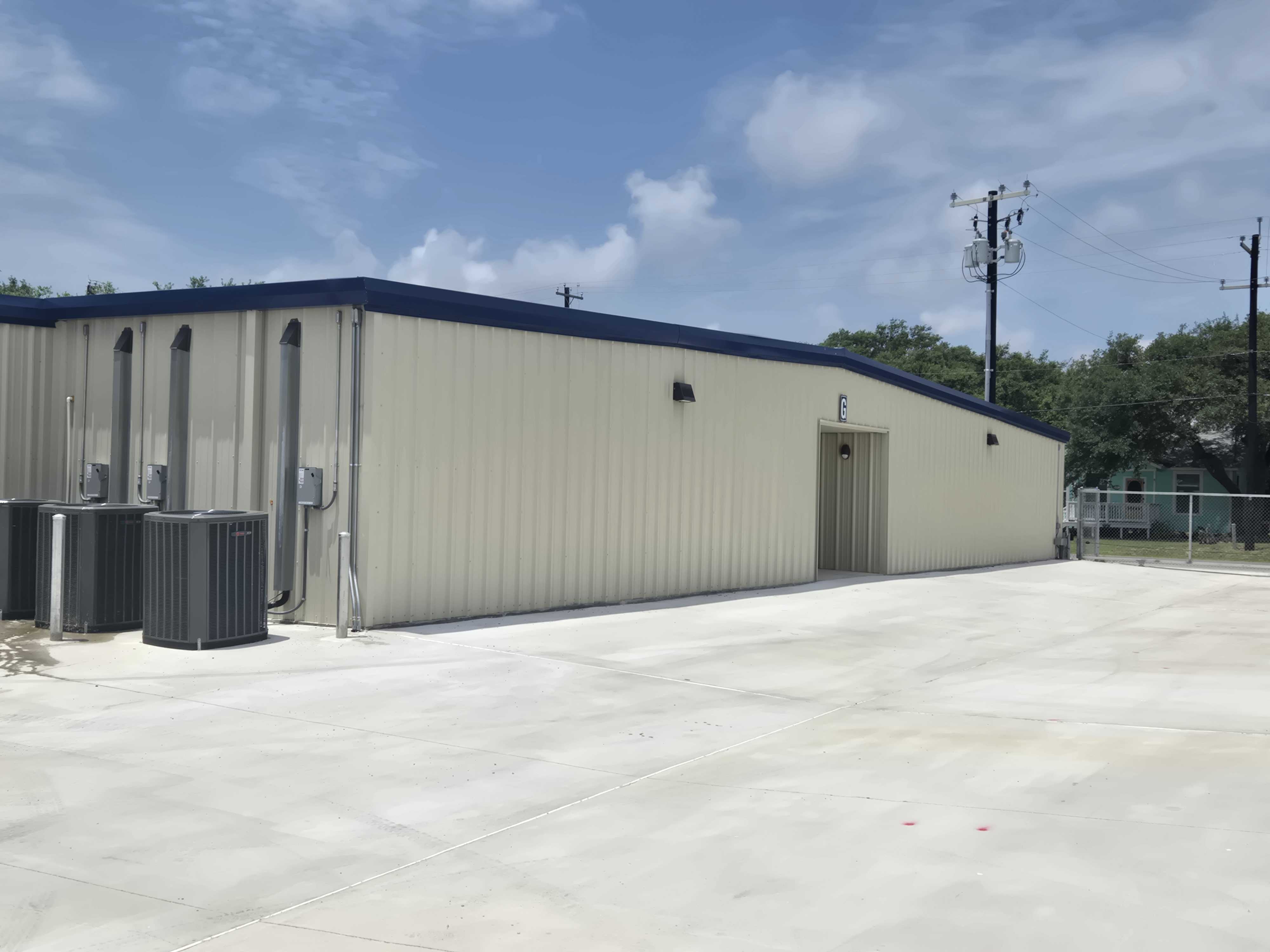 Exterior view of climate-controlled storage building with AC units at StowAway Storage in Rockport–Lamar, TX