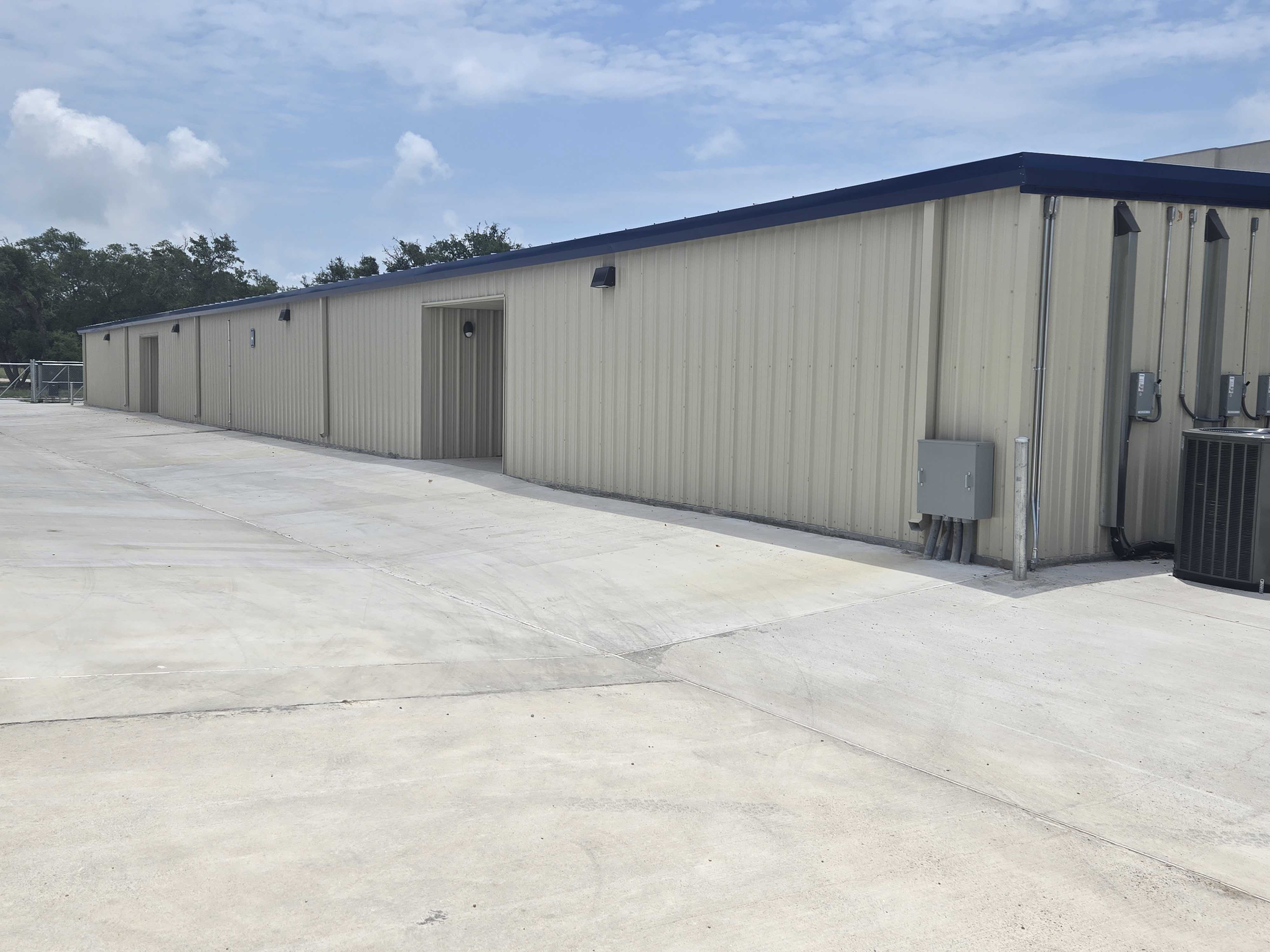 Climate-Controlled Commercial Storage Building at Spicewood Super Storage in Aransas Pass, TX Exterior of a secure, climate-controlled commercial storage building with concrete driveways at Spicewood Super Storage near Aransas Pass, TX.