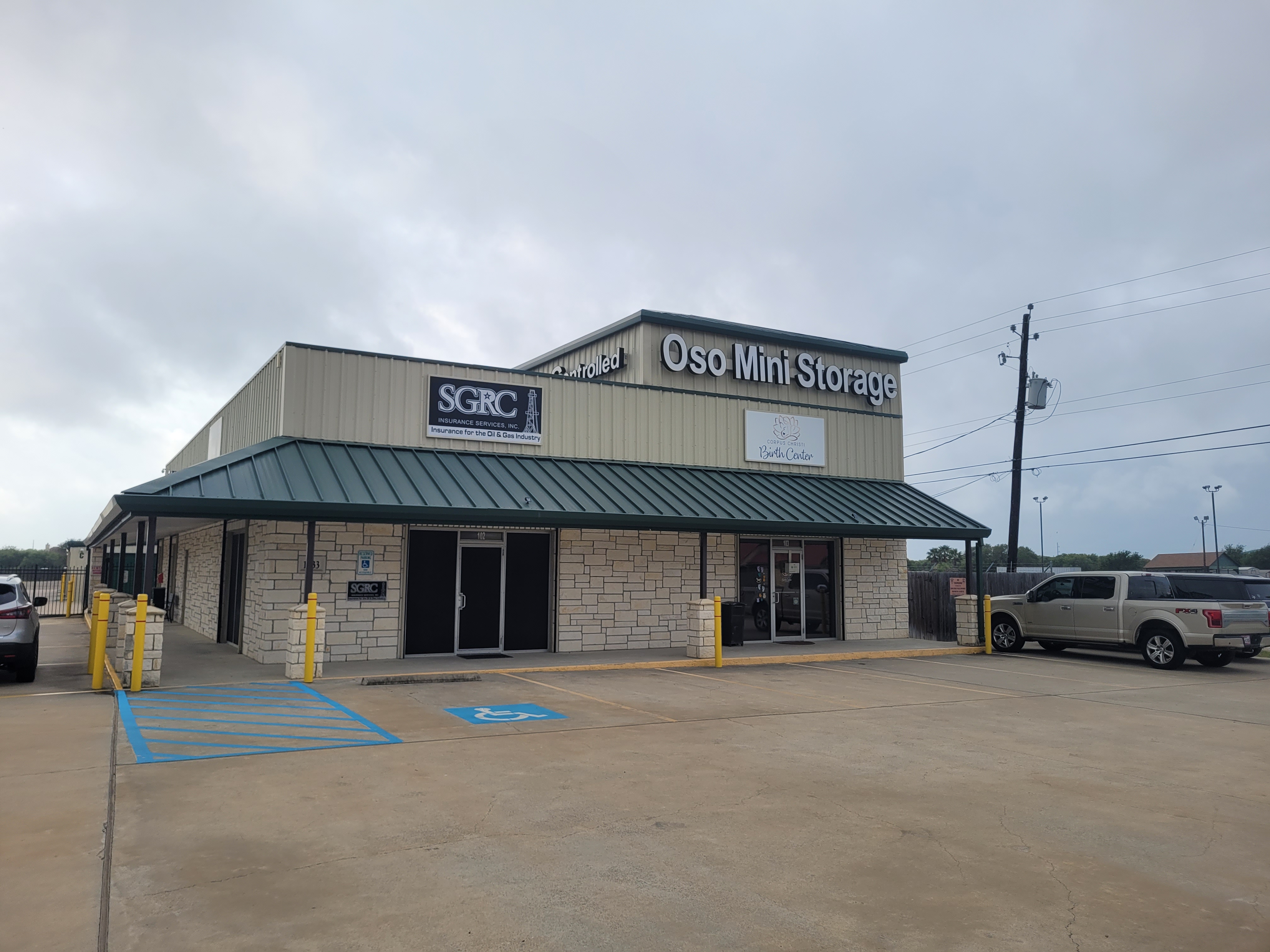 Exterior front view of Oso Mini Storage office in Flour Bluff, Corpus Christi, TX, with visible parking, signage, and handicap-accessible entry—local storage facility near Padre Island and NAS Corpus Christi.