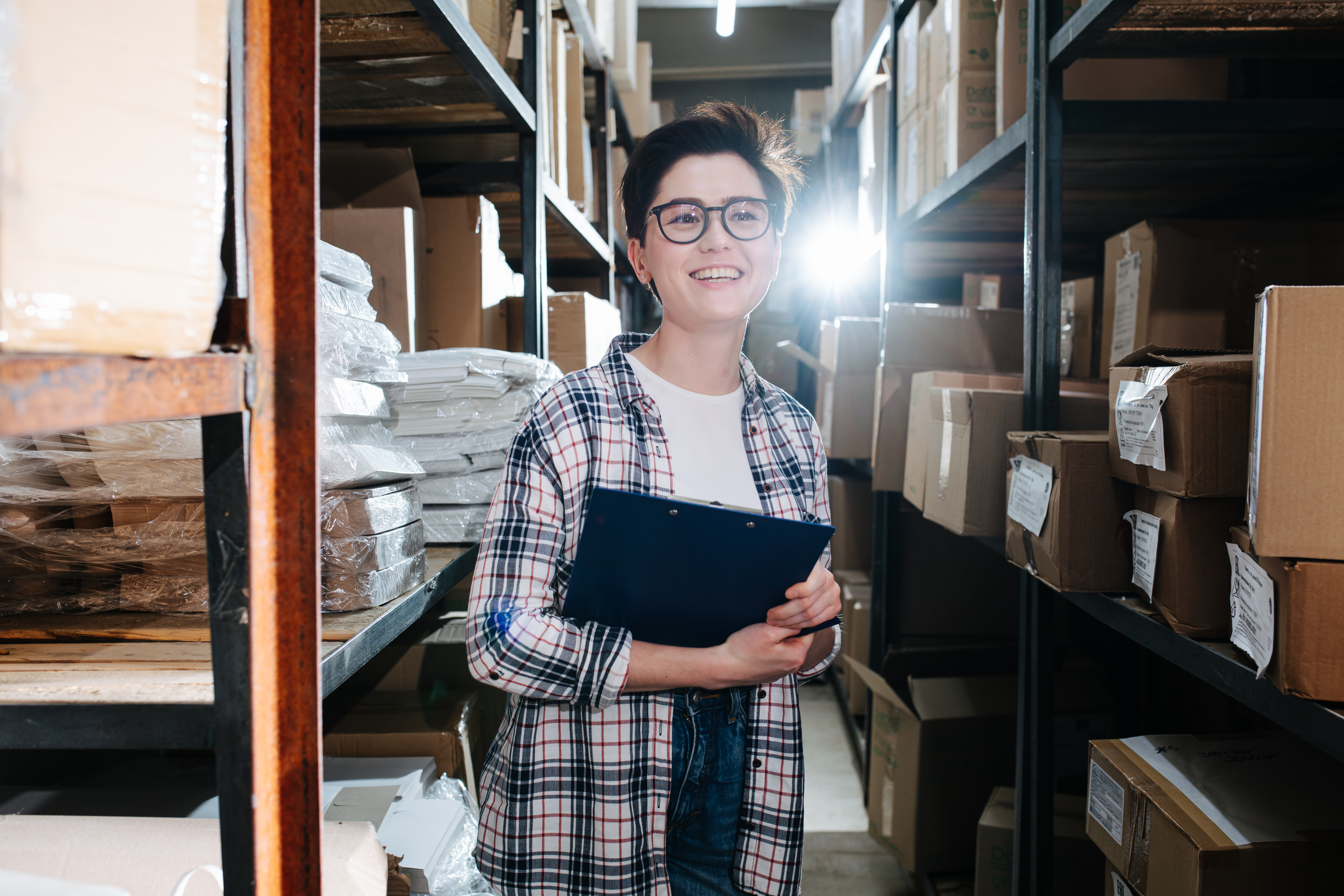 Small business owner organizing shelved inventory inside a clean climate-controlled storage unit in Corpus Christi, Texas