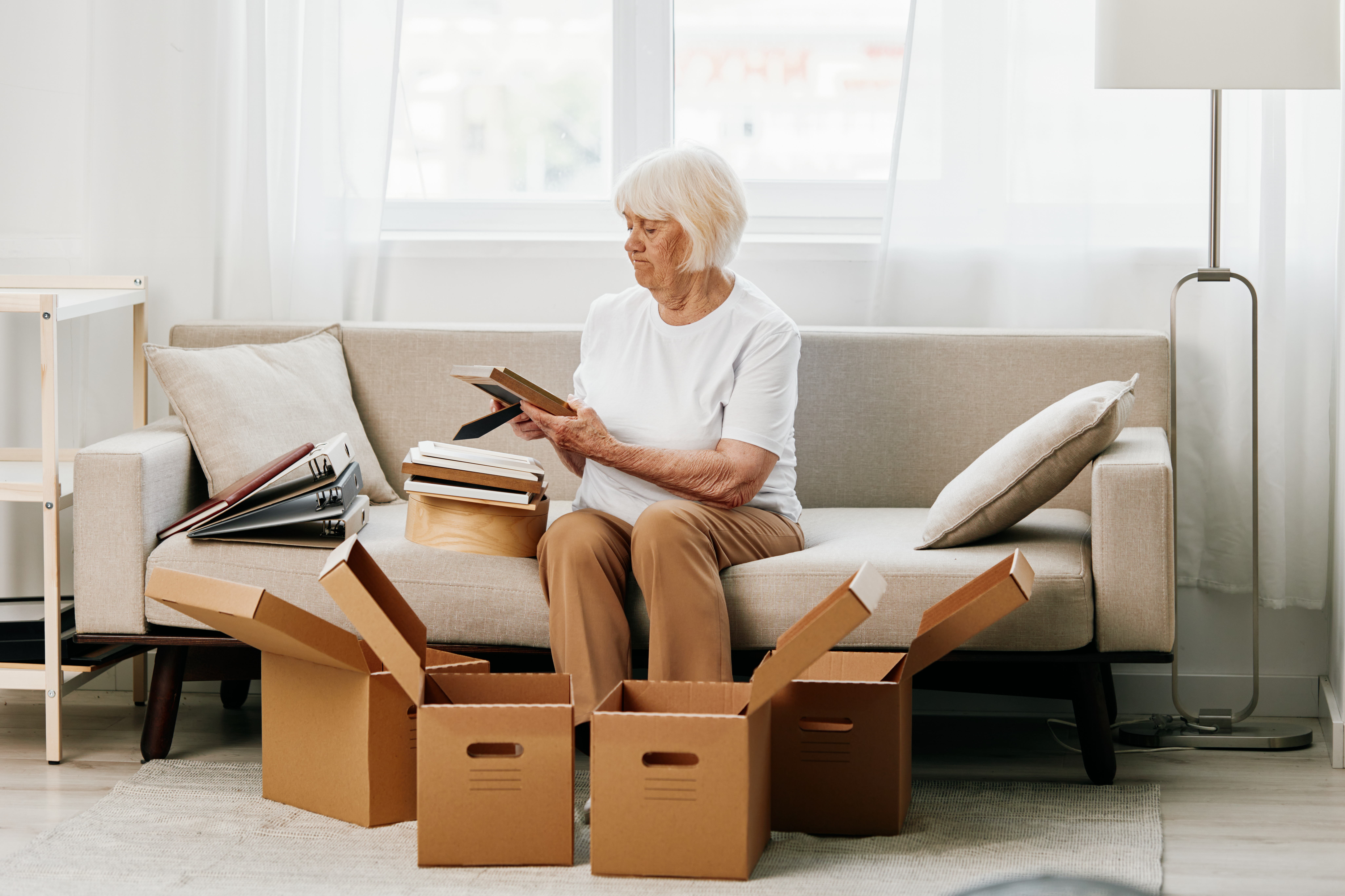 Senior woman and family member organizing belongings for downsizing storage in Lockhart, TX