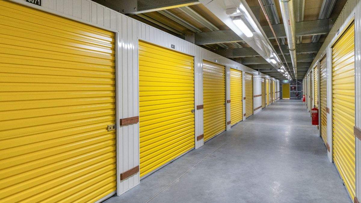 Non-climate storage unit packed with sealed plastic bins and moving blankets to prevent Texas summer heat and humidity damage