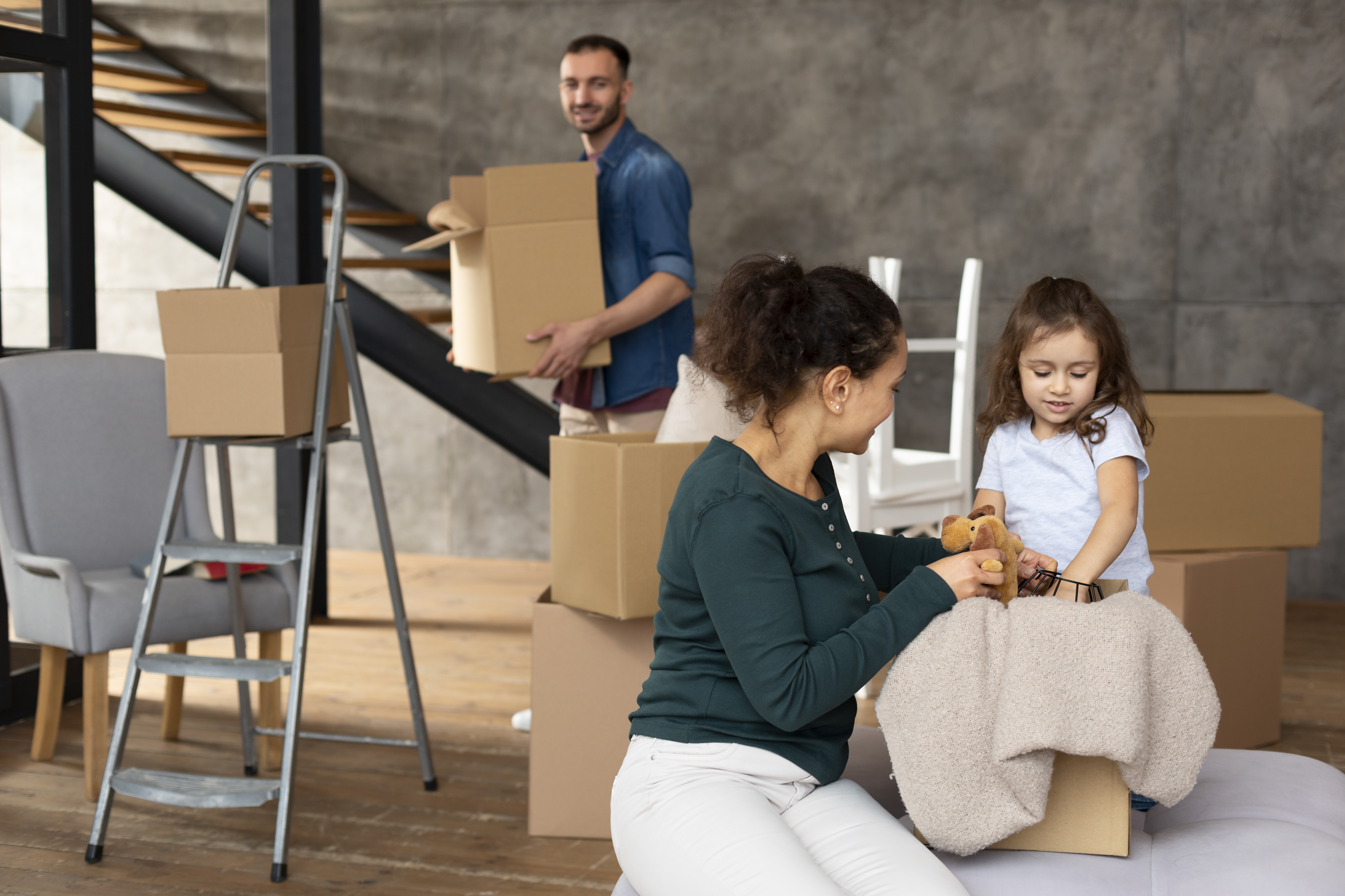 Family Moving Tips Richland Hills Haltom City, TX Family packing and labeling moving boxes during a relocation in Richland Hills and Haltom City, TX