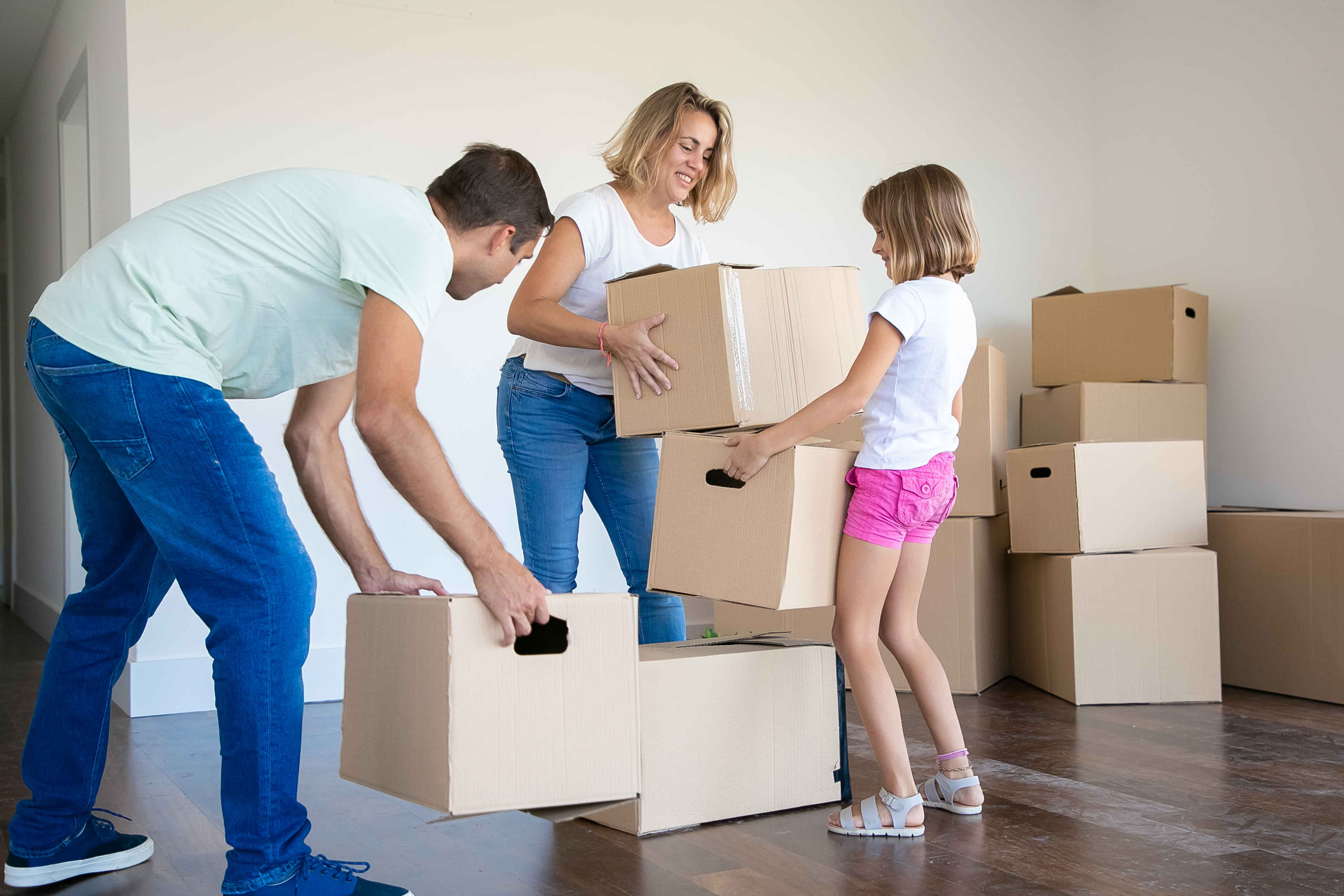 Busy family loading organized boxes into a clean drive-up storage unit in Corpus Christi, Texas