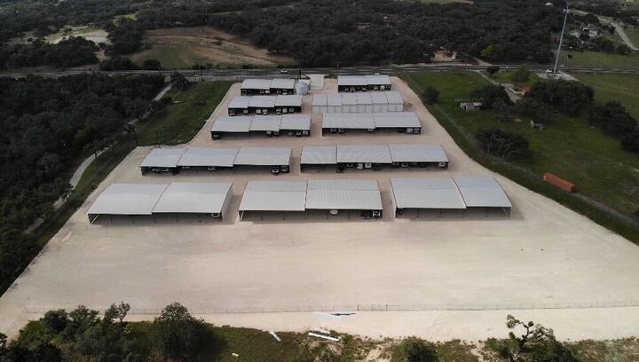 Aerial view of covered RV and boat storage facility near Bulverde, Texas with wide drive aisles and secure gated access