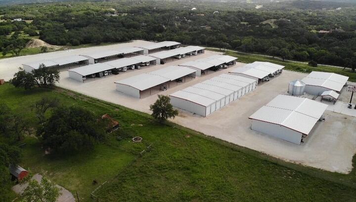 Boerne TX Covered RV and Boat Storage Facility β Secure Parking Near Bergheim Aerial view of covered RV and boat storage facility in Boerne, Texas with secure gated access, wide drive lanes, and enclosed parking units near Bergheim