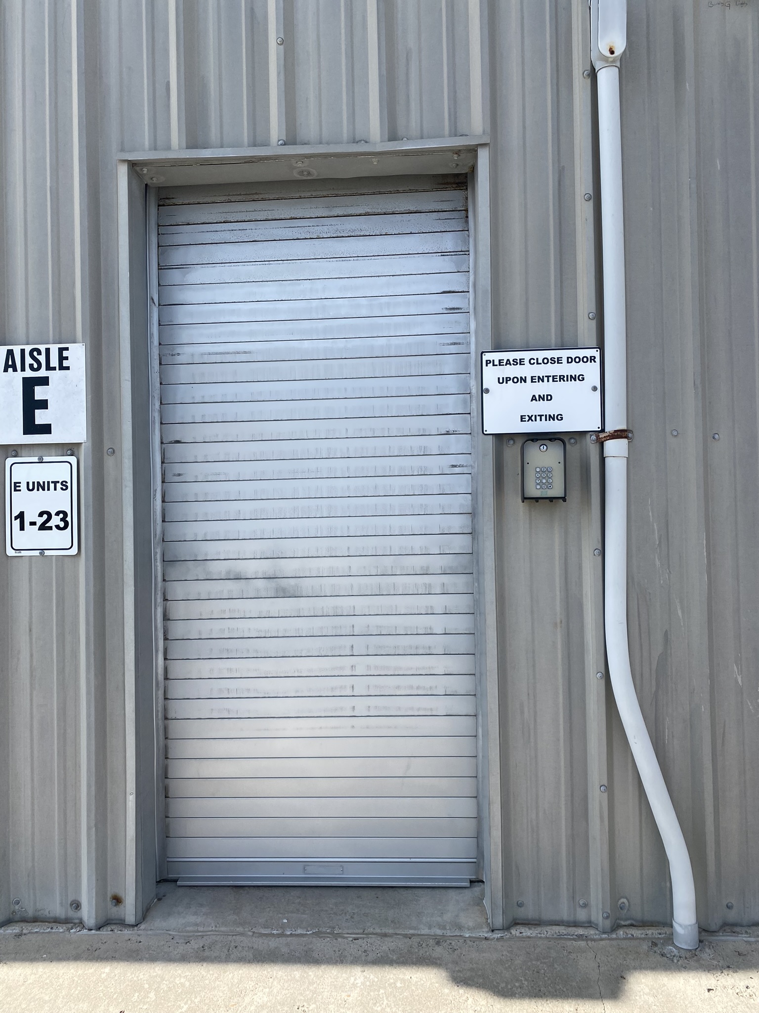 Exterior row of drive-up storage units at OSO Climate Storage near Galveston, TX, ideal for storing off-season items for vacation rental owners.