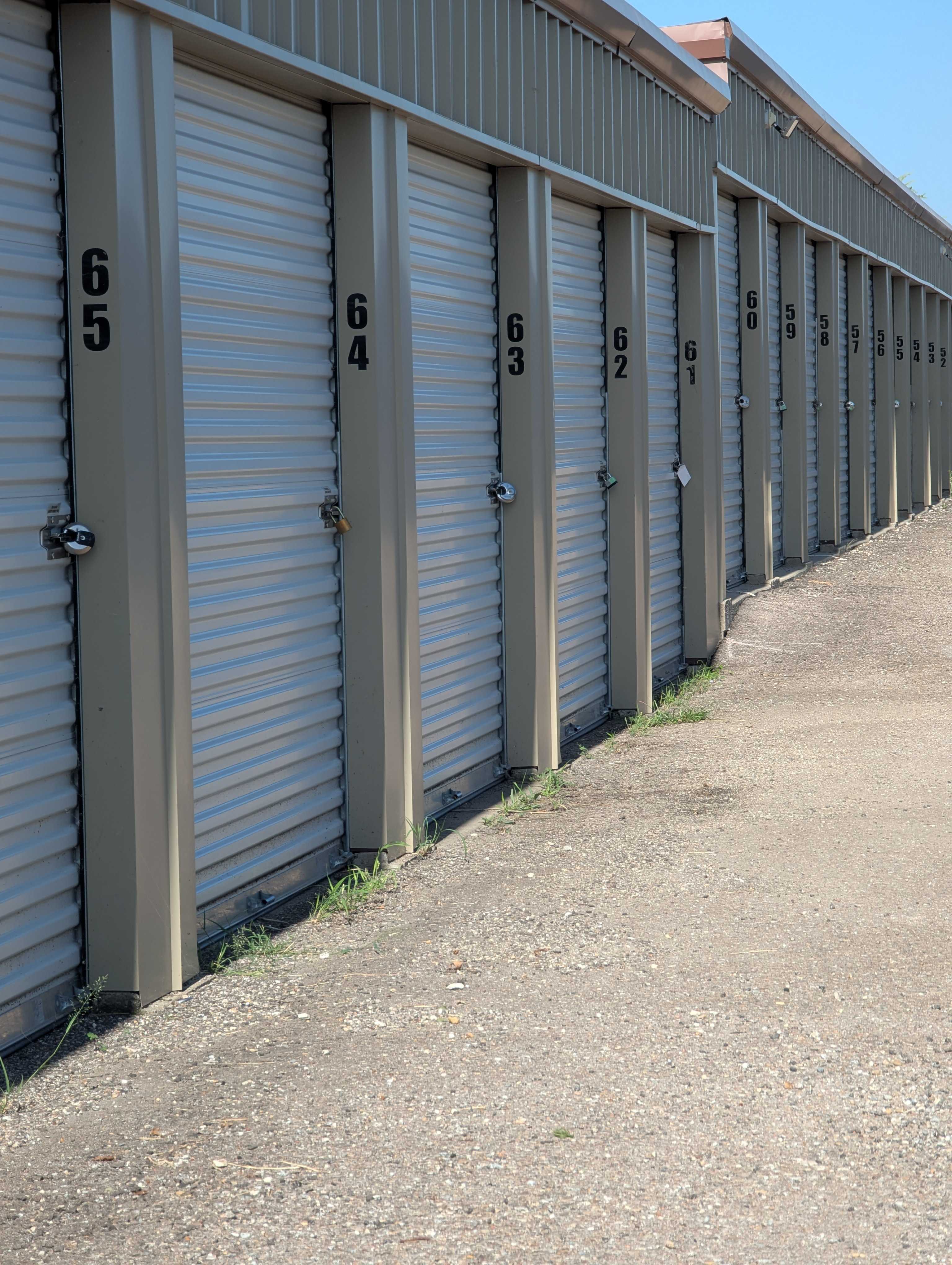 Row of secure drive-up storage units with numbered doors at Royse City Secure Storage near Fate and Caddo Mills, TX
