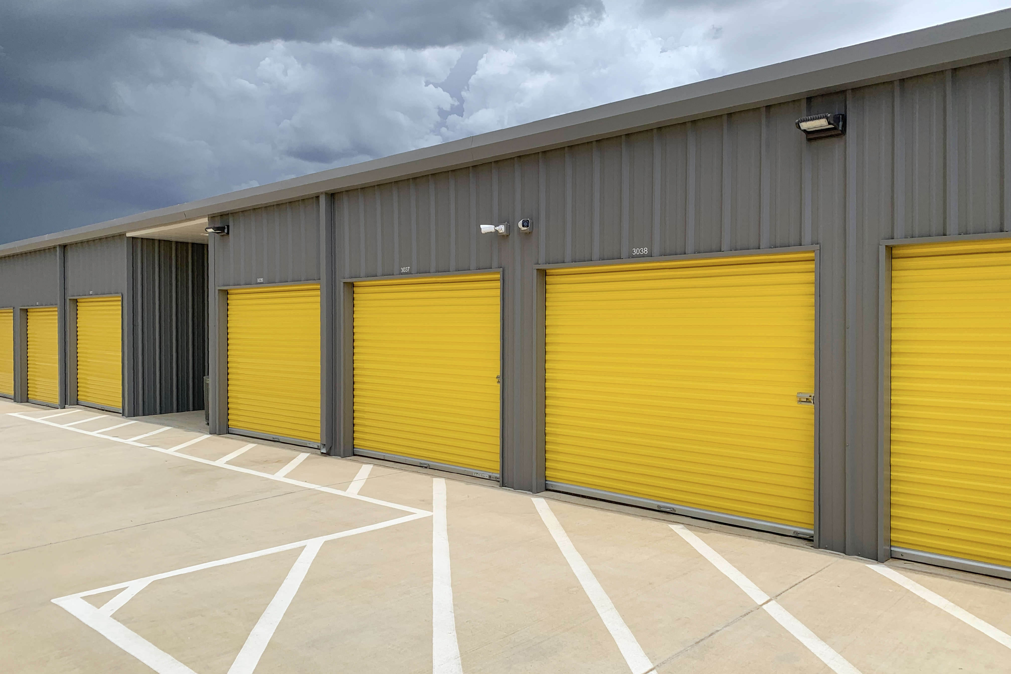 Round Rock contractor accessing organized off-site drive-up storage unit for tools and equipment