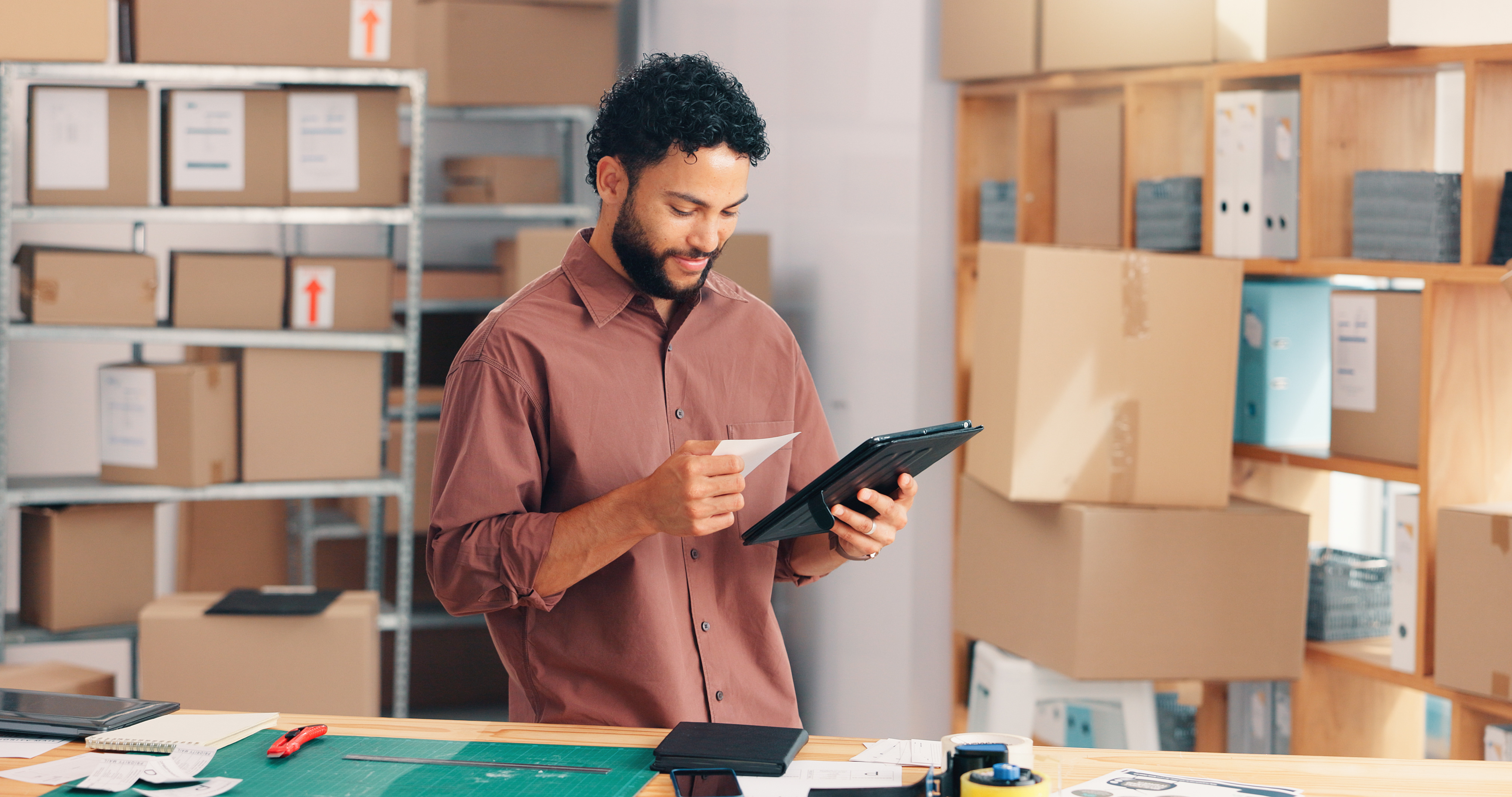  Small business owner organizing inventory and supplies in a clean storage unit in Waxahachie, TX, to reduce office overhead