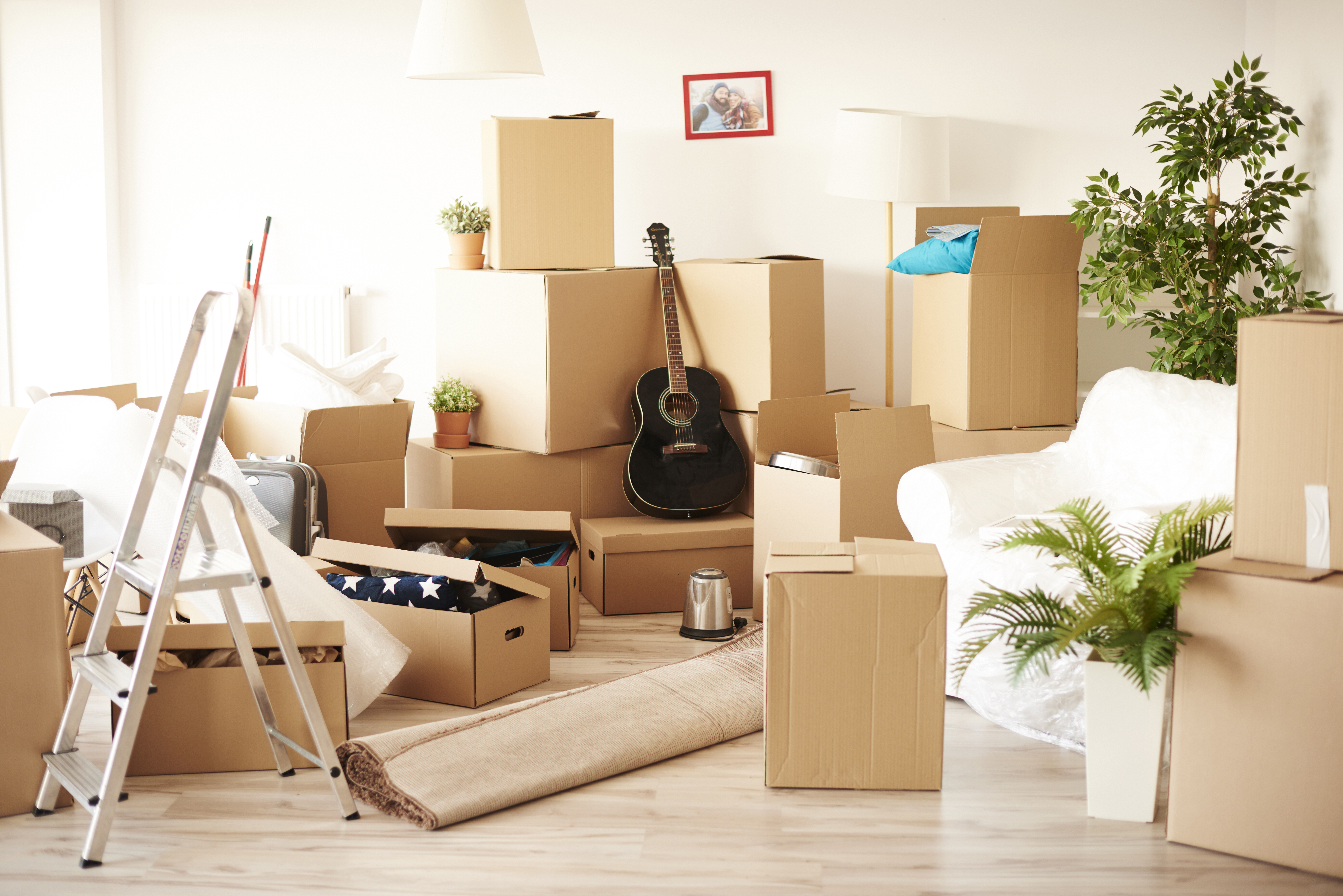 Open drive-up storage unit filled with organized furniture and boxes showing 10x10 vs 10x20 storage space