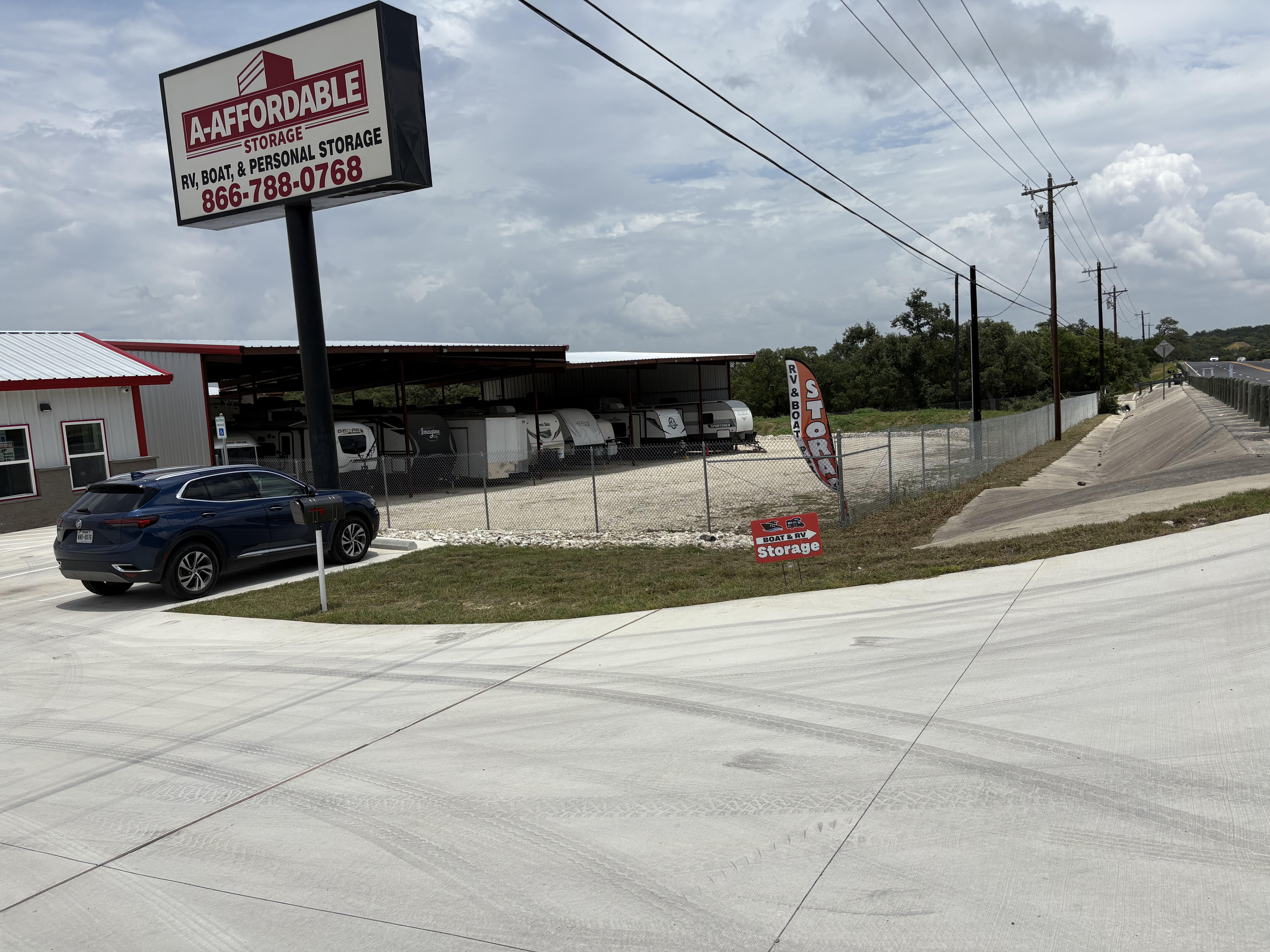 Exterior view of A-Affordable Storage facility in Boerne, TX offering RV, boat, and personal storage with gated access and covered parking