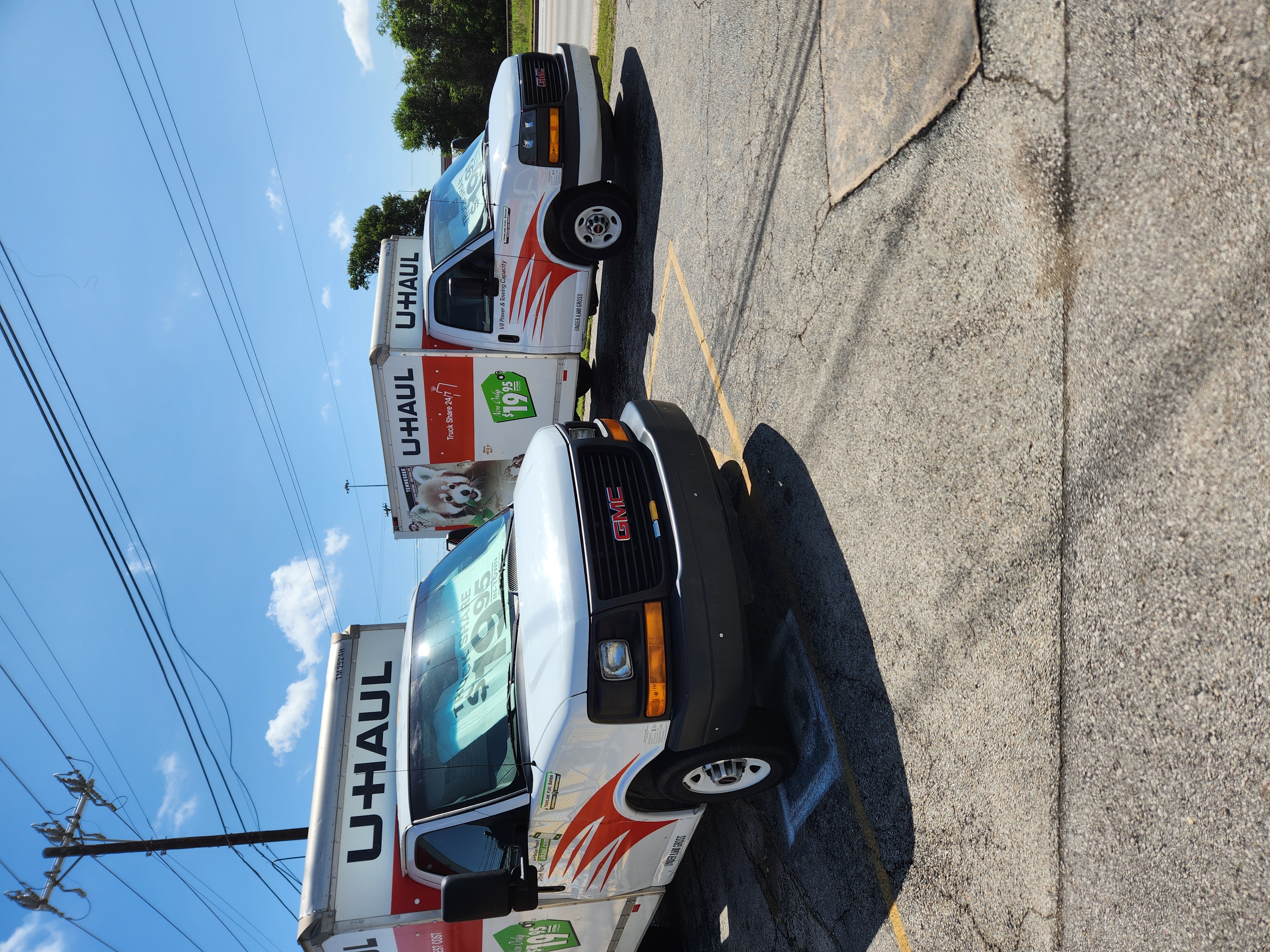 U-Haul Moving Trucks at Round Rock Secure Storage – Garage Overflow Solutions for Hutto Families Two U-Haul moving trucks parked at Round Rock Secure Storage, offering local storage and moving solutions for Hutto families with garage overflow.