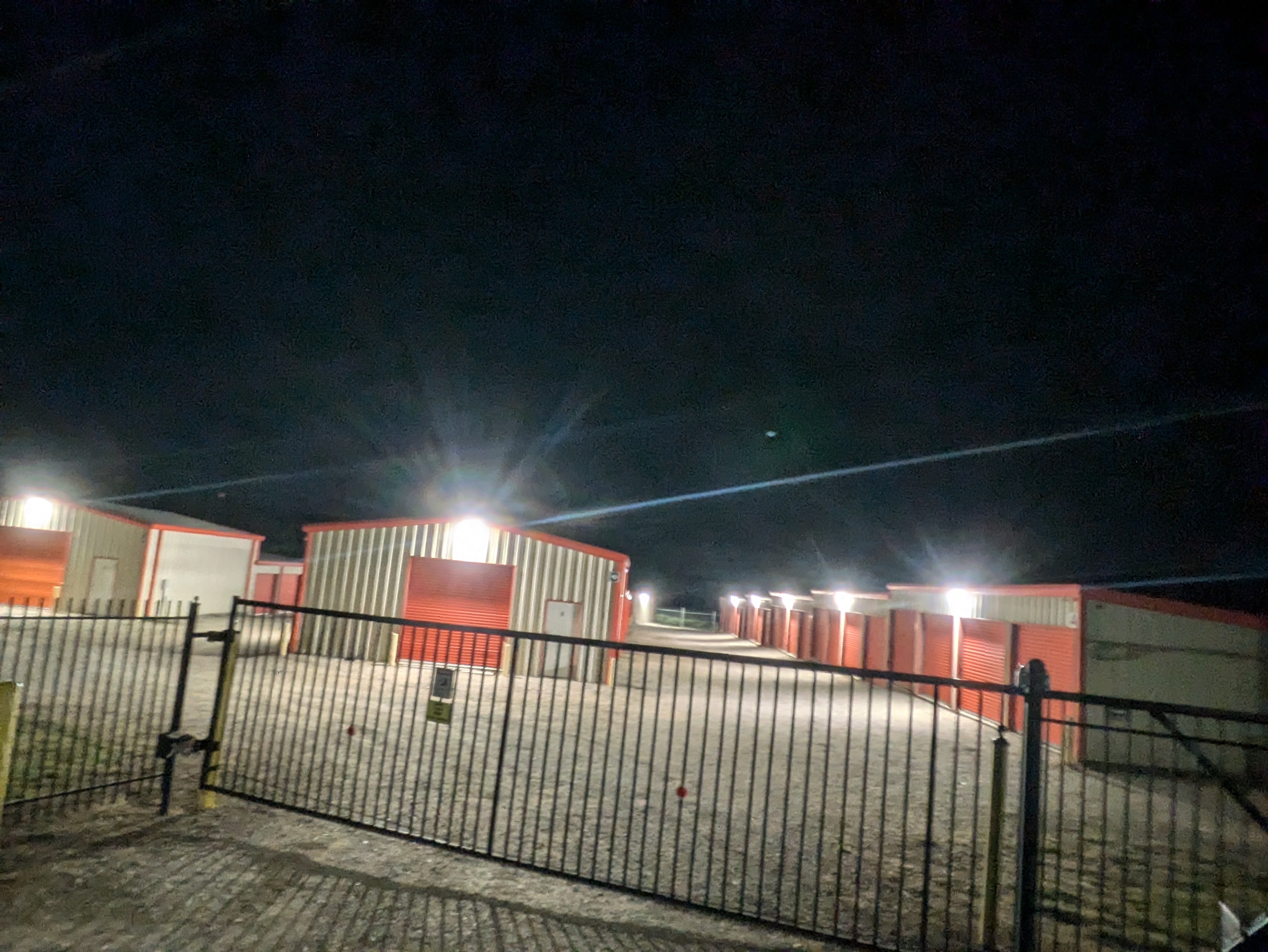 Nighttime Security Lighting at Athens Secure Storage | Gated Storage in Athens, TX Secure self-storage facility with gated entrance and bright LED lighting at night at Athens Secure Storage & Parking in Athens, TX.