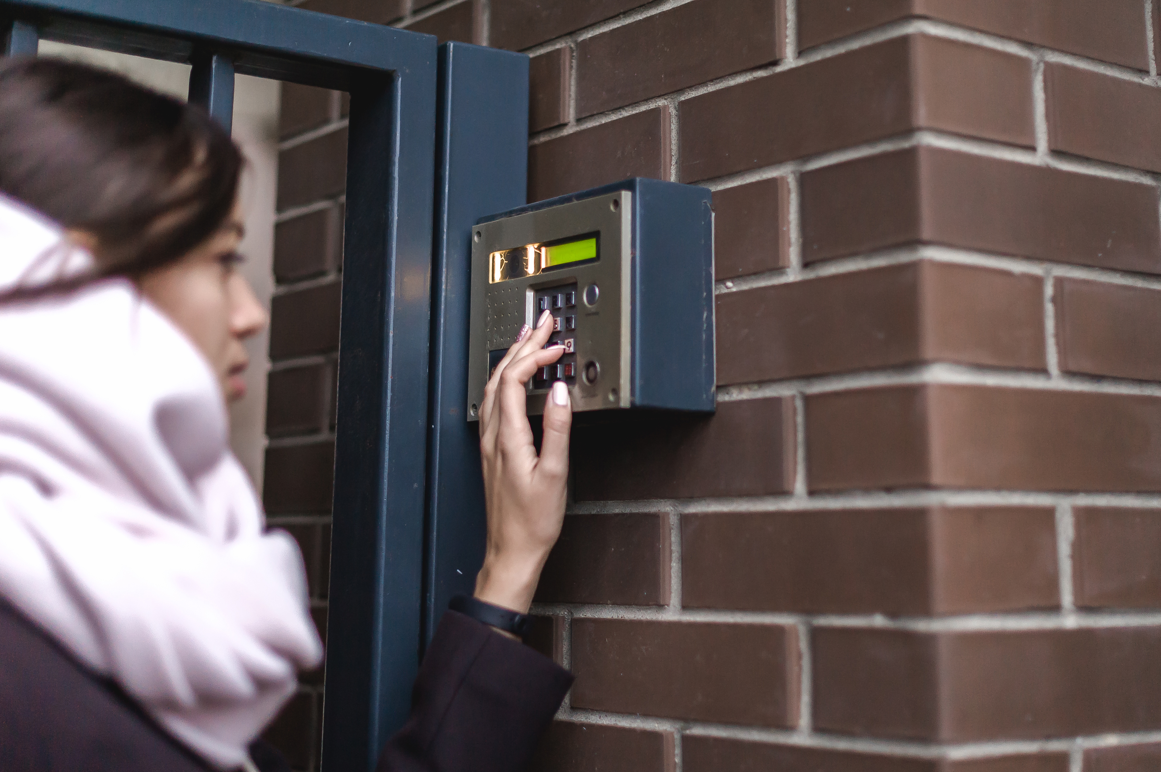 Person entering personalized PIN code at a gated storage facility in North Richland Hills, TX