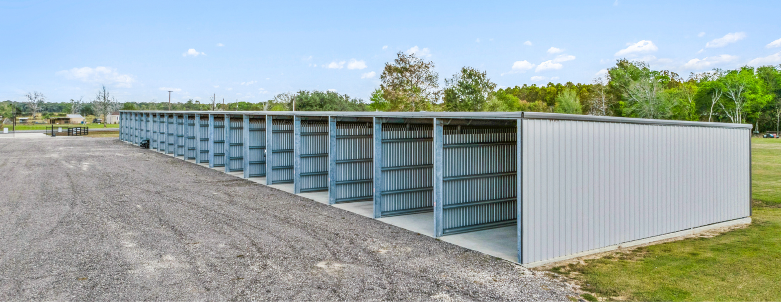 Row of large, open climate-controlled storage units at Rethink Self Storage in Hamshire, TX, providing ample space for storing RVs, boats, and other valuable items. The facility is clean and secure, with easy drive-up access.