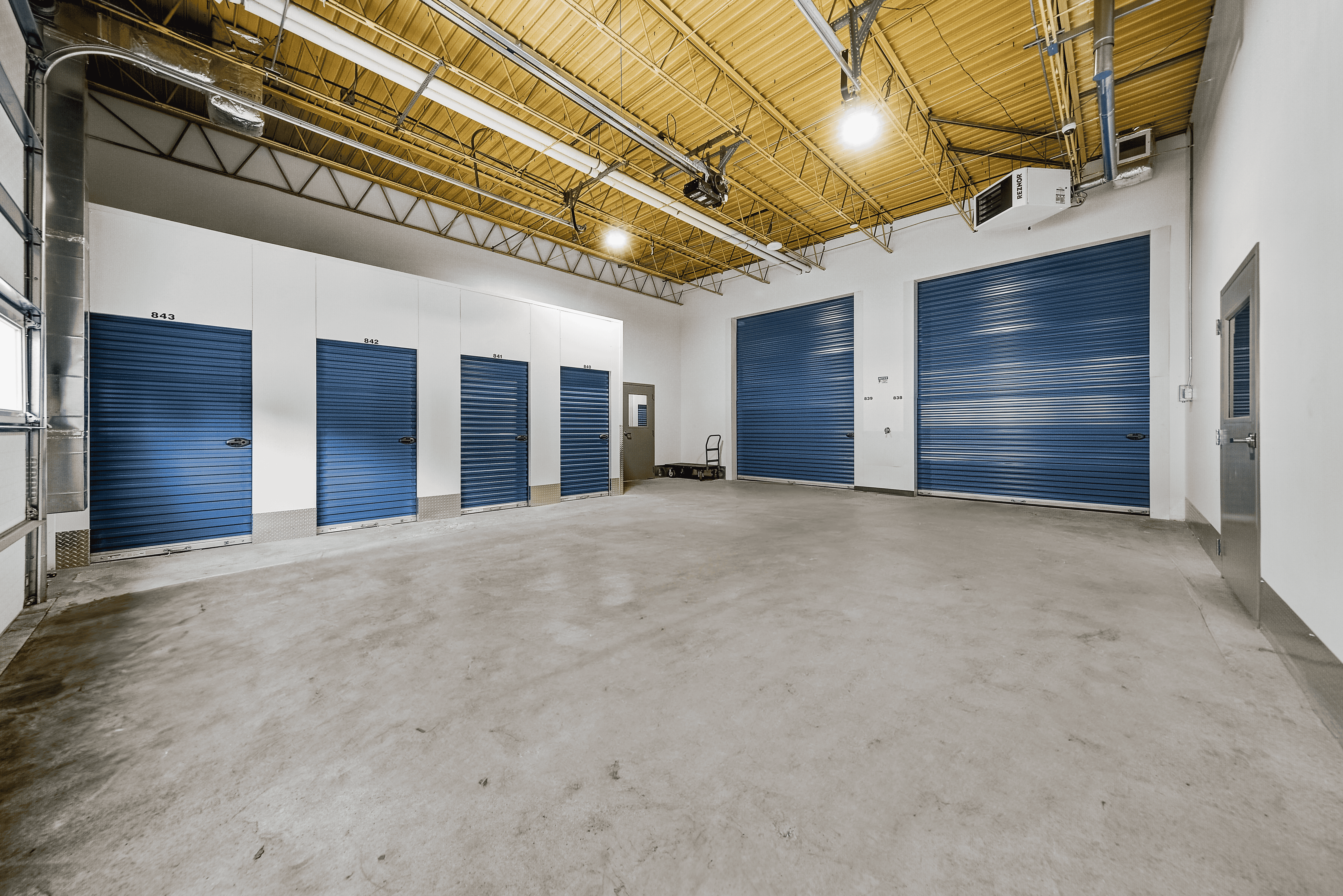 Climate-controlled storage units of various sizes at Storage on 7th in Faribault, Minnesota, with a wide drive-in loading area for tenants.