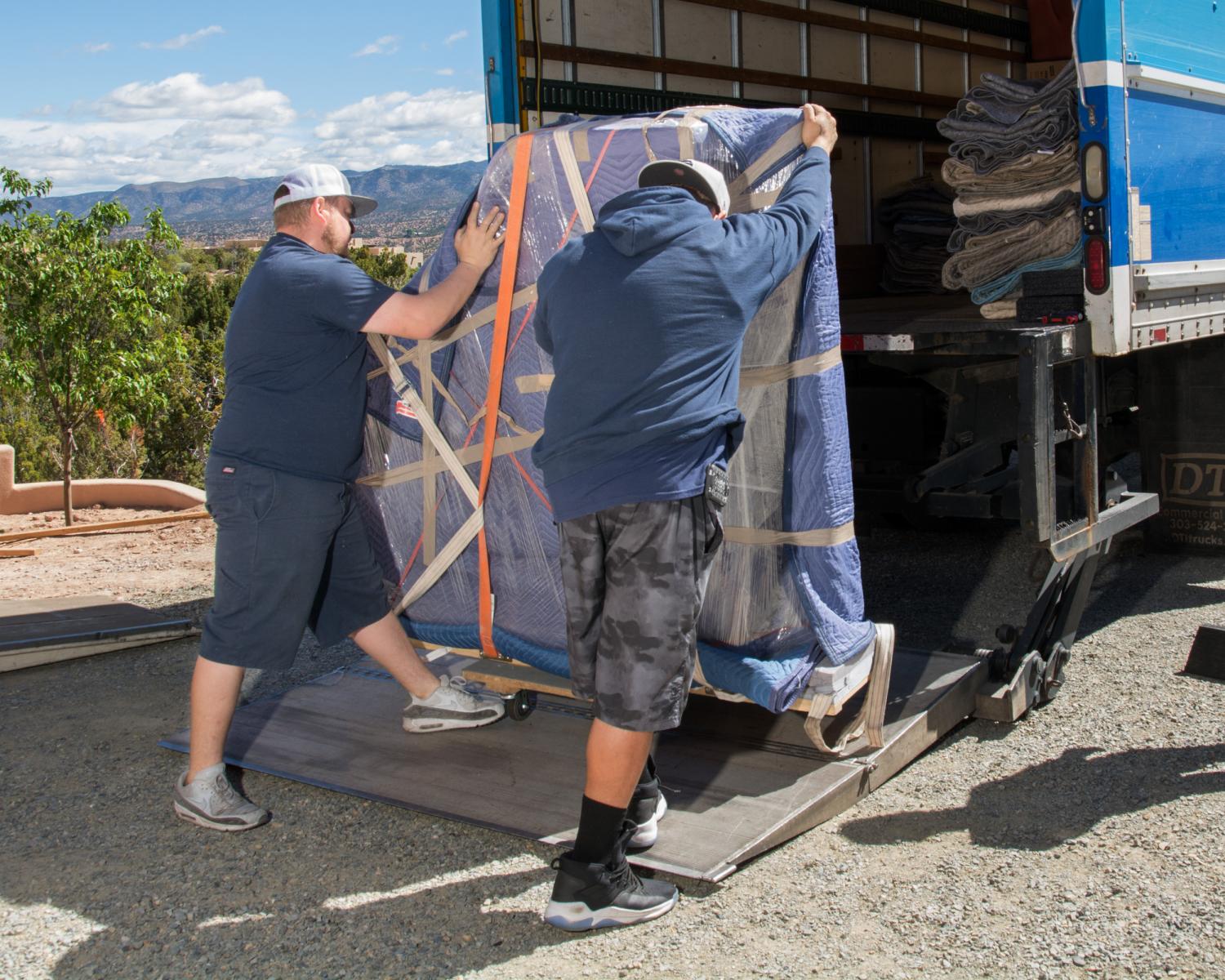 Two guys loading a truck
