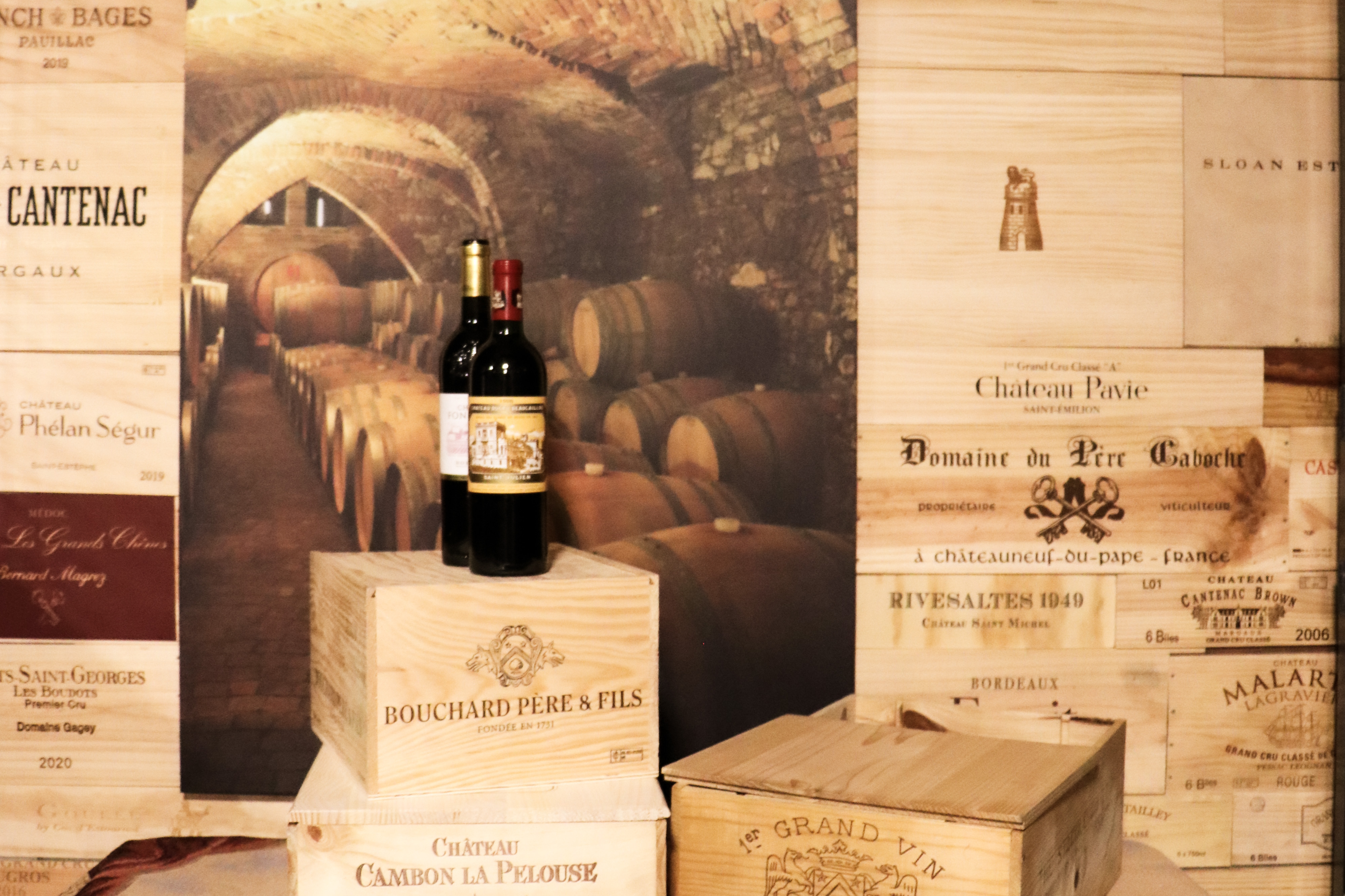 Two bottles of wine on French wine crates inside Cáve a Vin at StorSpaces.