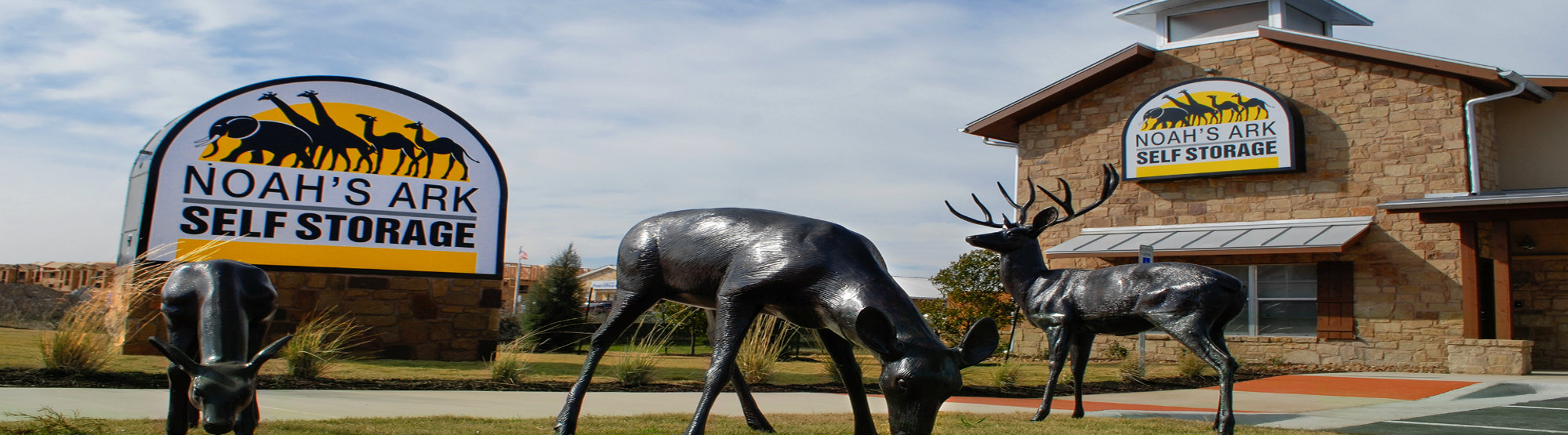 front sign and entrance to noah's ark self storage. metal deer statues out front