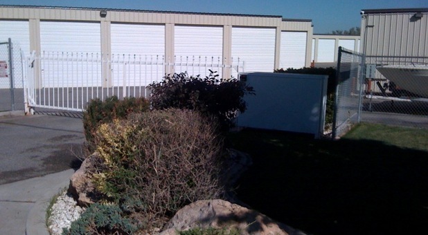 self storage units behind a perimeter fence and automatic gate
