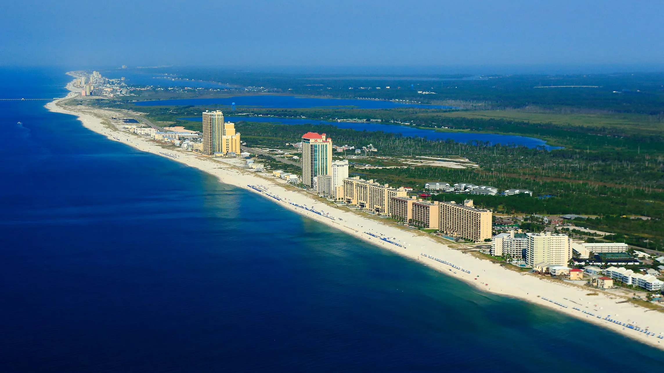 Gulf Shores, Alabama.Photo: Gulf Shores & Orange Beach Tourism Aerial view of Gulf Shores, and Orange Beach Alabama, with white-sand beaches, turquoise water, and beachfront condos.