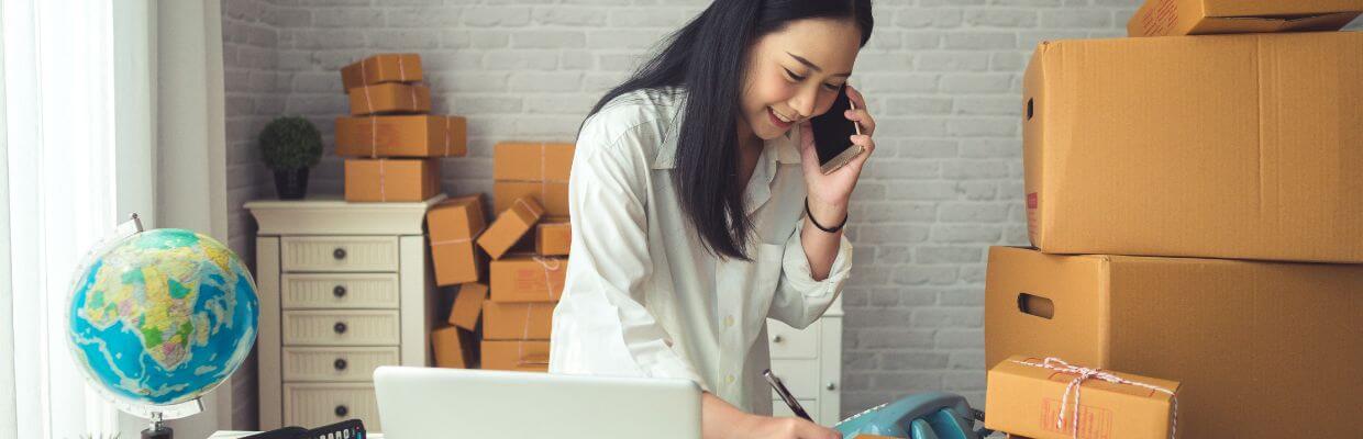 small business owner taking orders and packing boxes