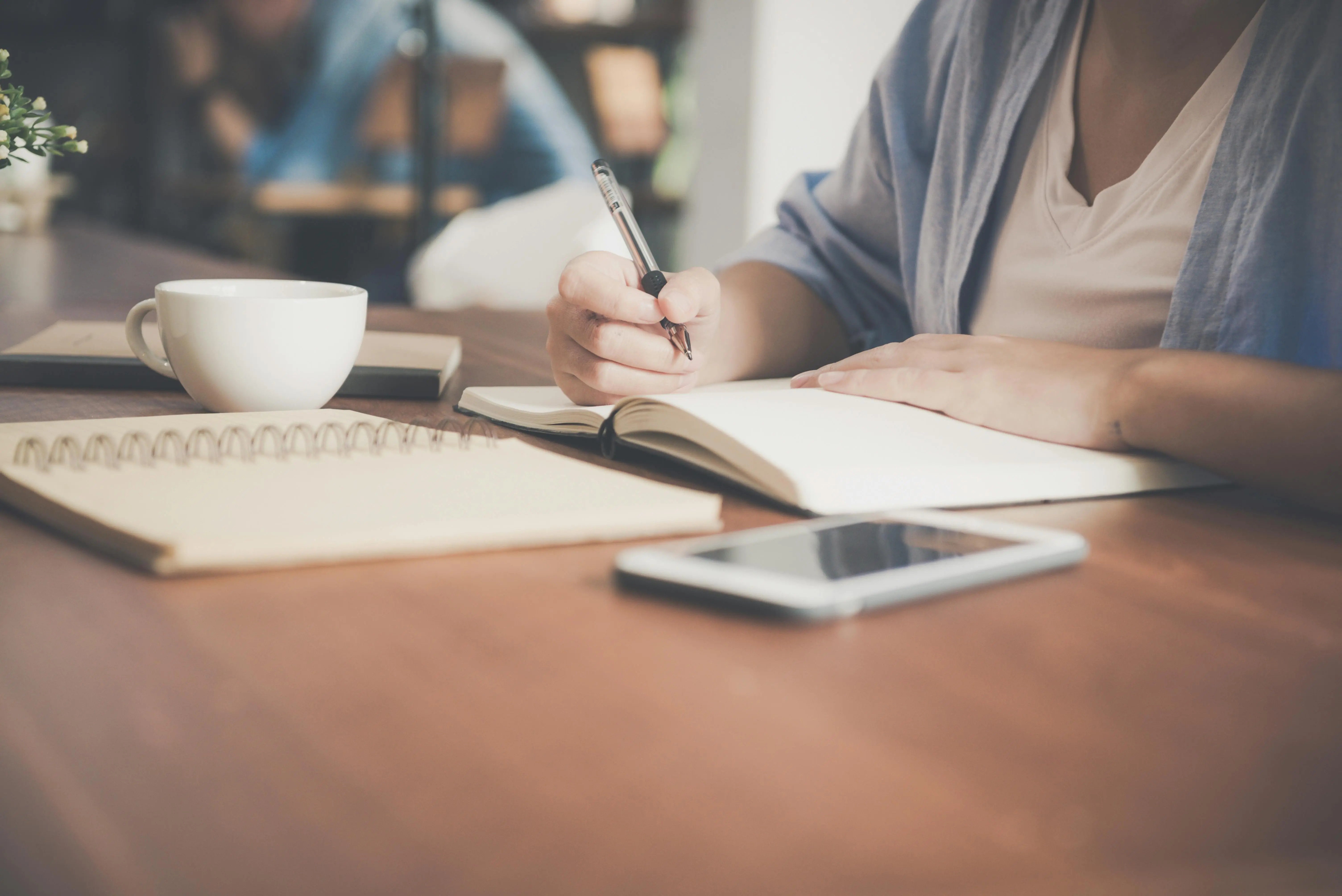 person writing in notebook