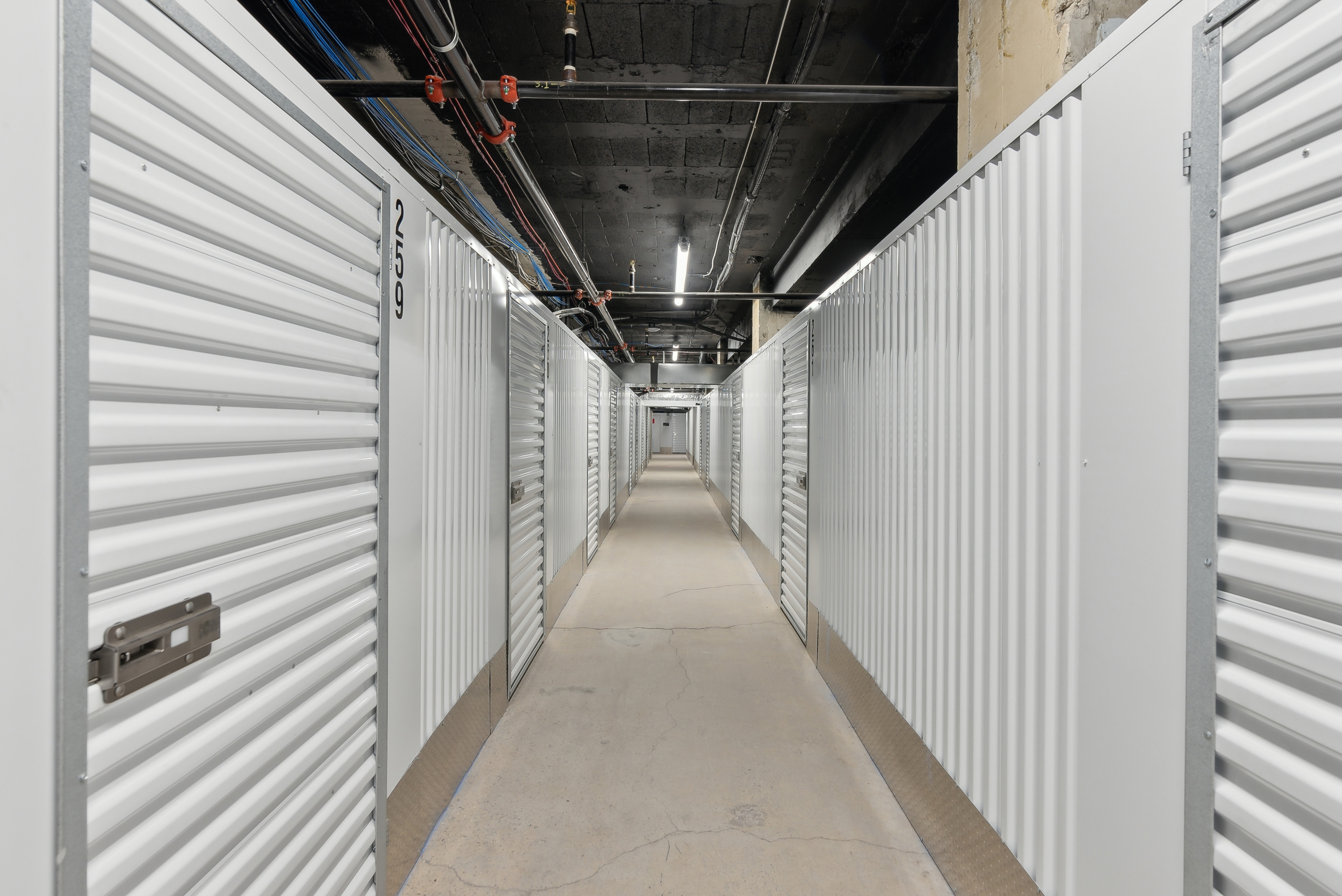 Row of indoor self-storage units with closed metal doors
