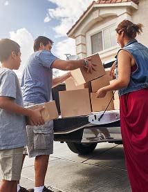 Family loading cardboard boxes