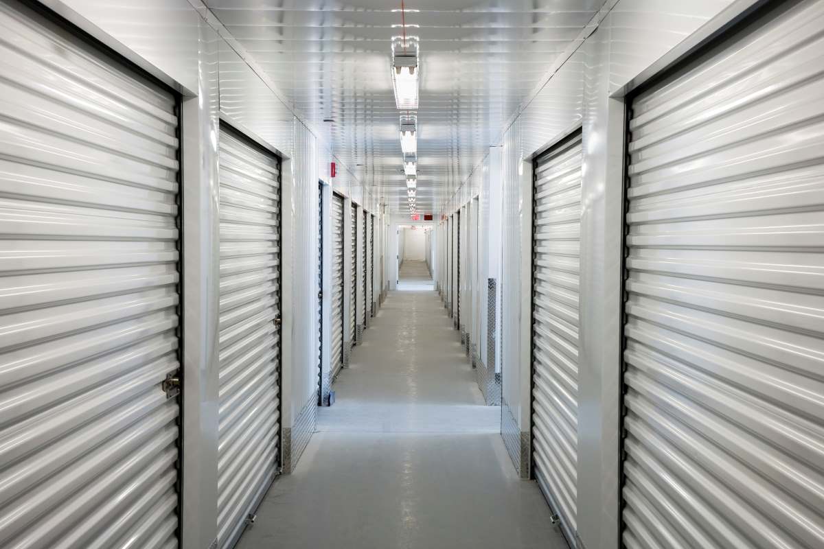  A series of self storage units lining an indoor hallway  