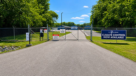 Gated entrance of Oglethorpe self-storage facility with climate control availability sign.