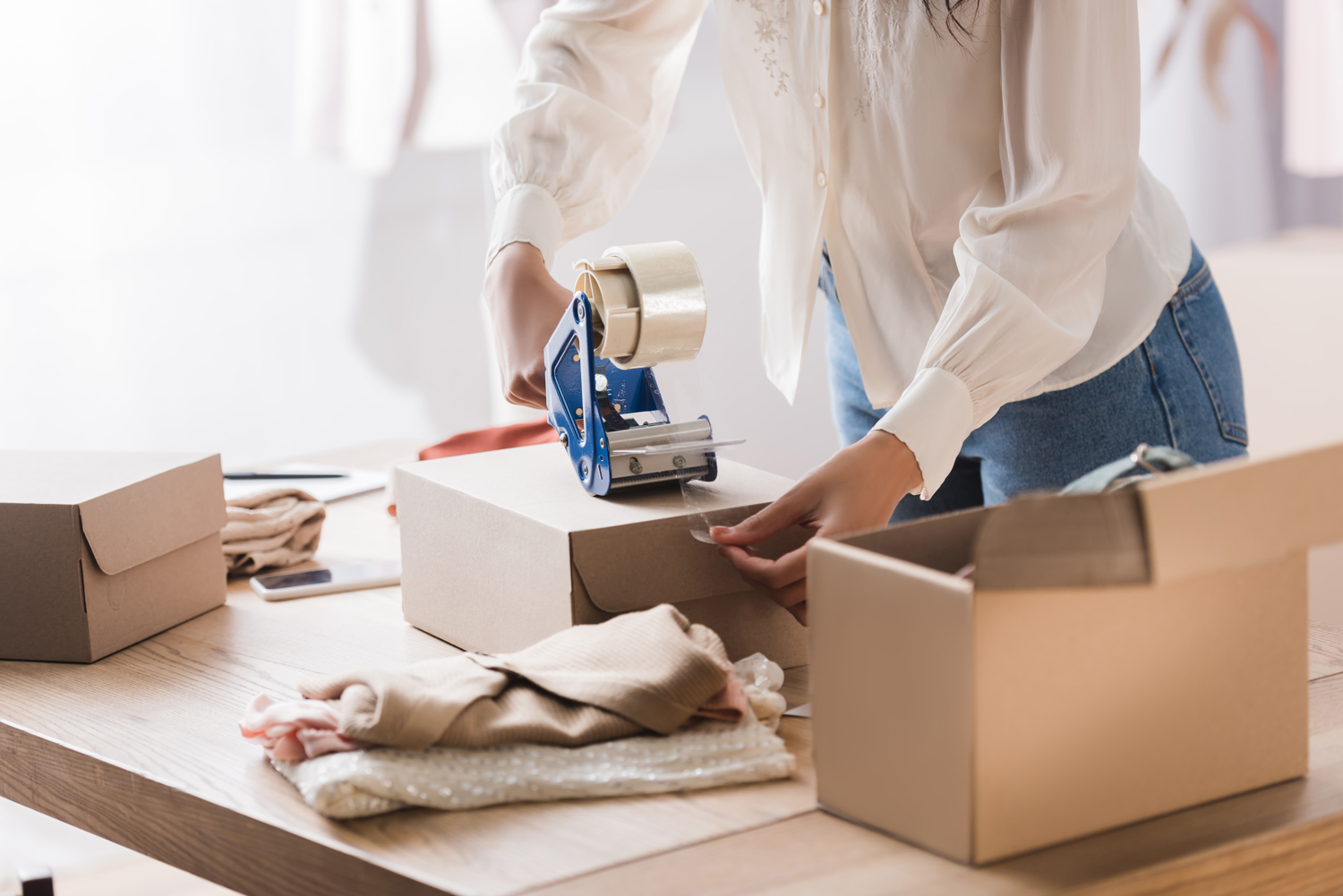Woman packing orders for ecommerce business