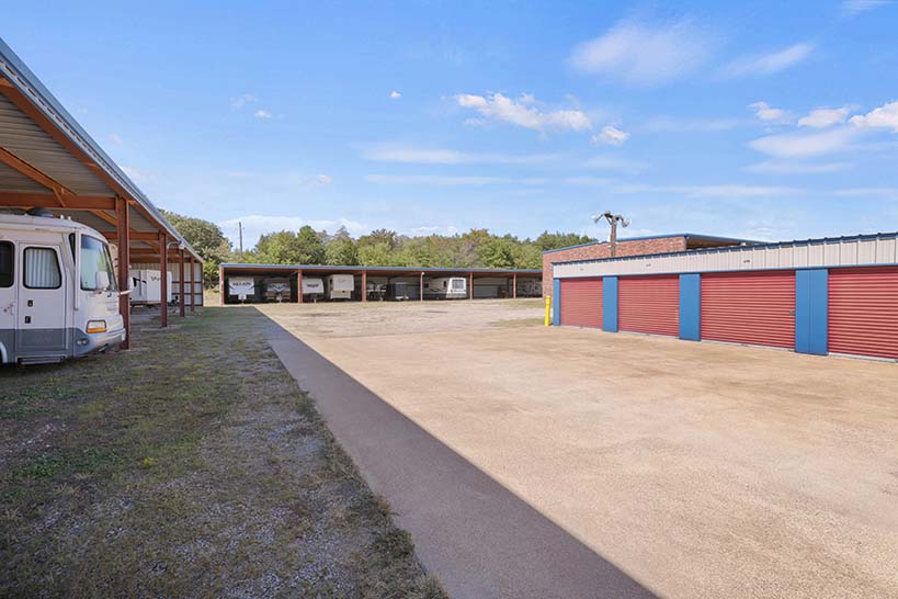 Covered RV parking beside drive-up storage units