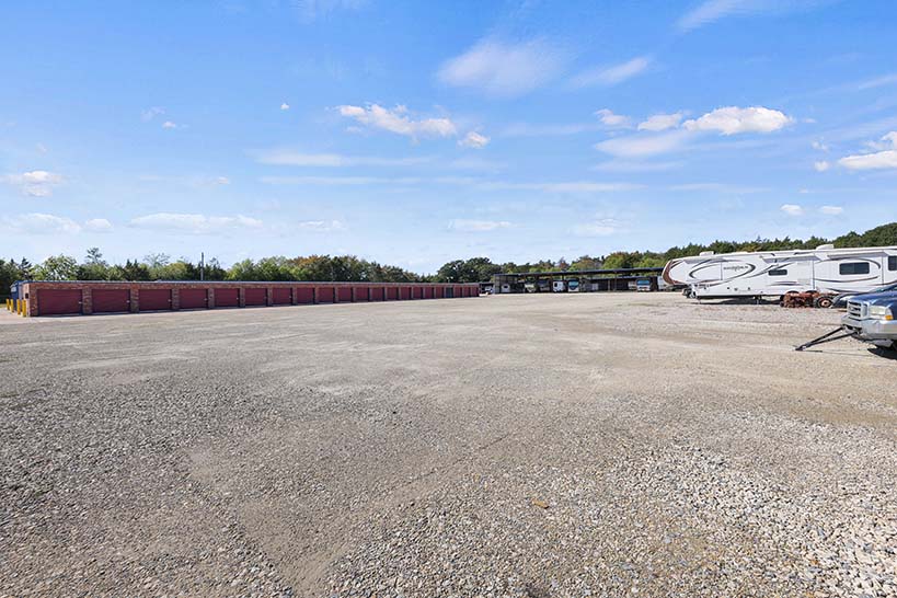 Open gravel lot with RVs and room to maneuver