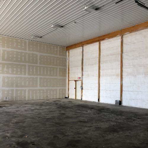 interior of a closed warehouse space, smooth concrete floor, concrete block wall