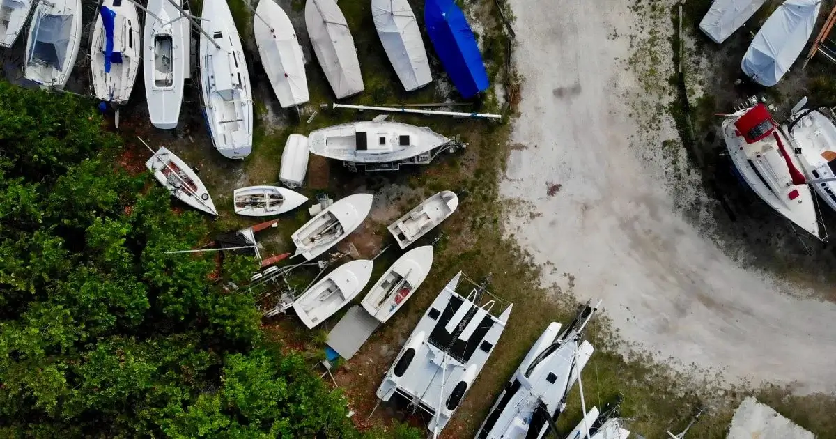 Aerial view of boats in outdoor storage lot.