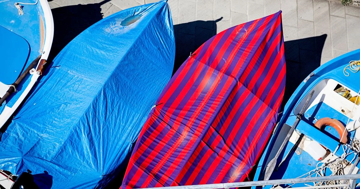First Launch: Taking Your Boat Out of Storage in Florida Small boats covered with tarps in outdoor storage area